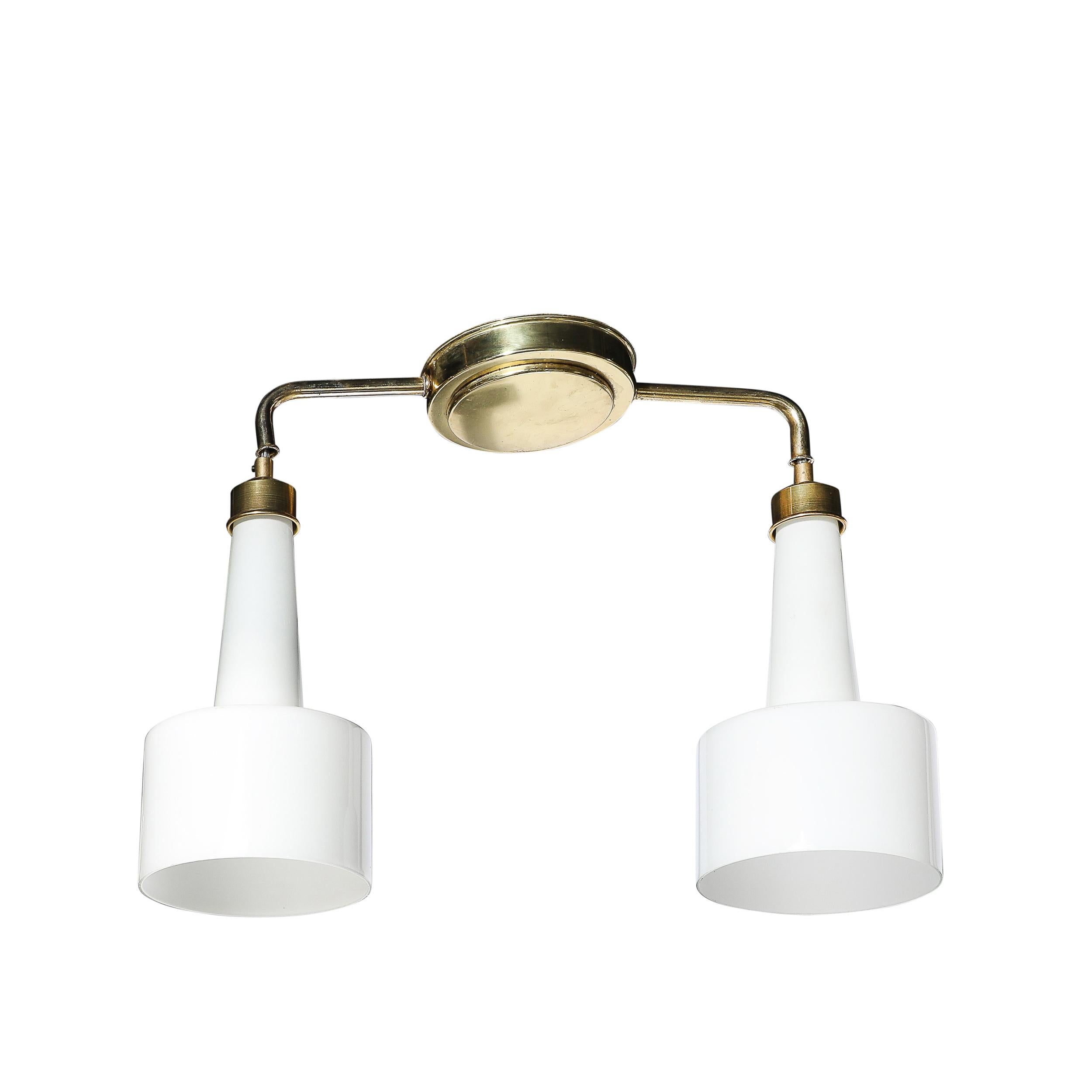Questo splendido lampadario a sospensione del Mid-Century Modernist, creato in Italia intorno al 1950, rappresenta la sofisticata etica del design minimalista del dopoguerra. Caratterizzato da due globi in vetro lattimo stampati e sostenuti da