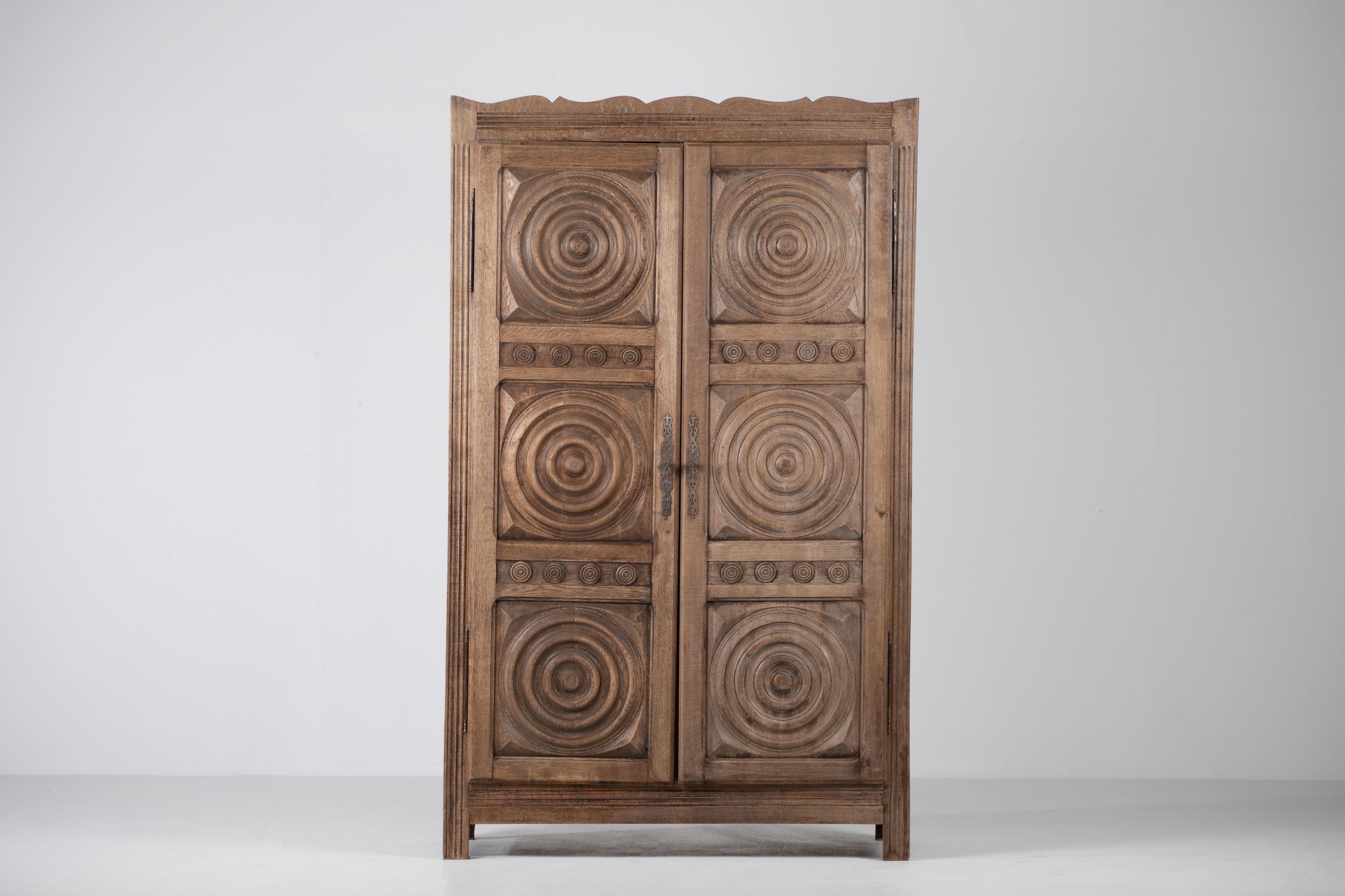 Large oak sculpted wardrobe in style of Charles Dudouyt.
France c. 1950.