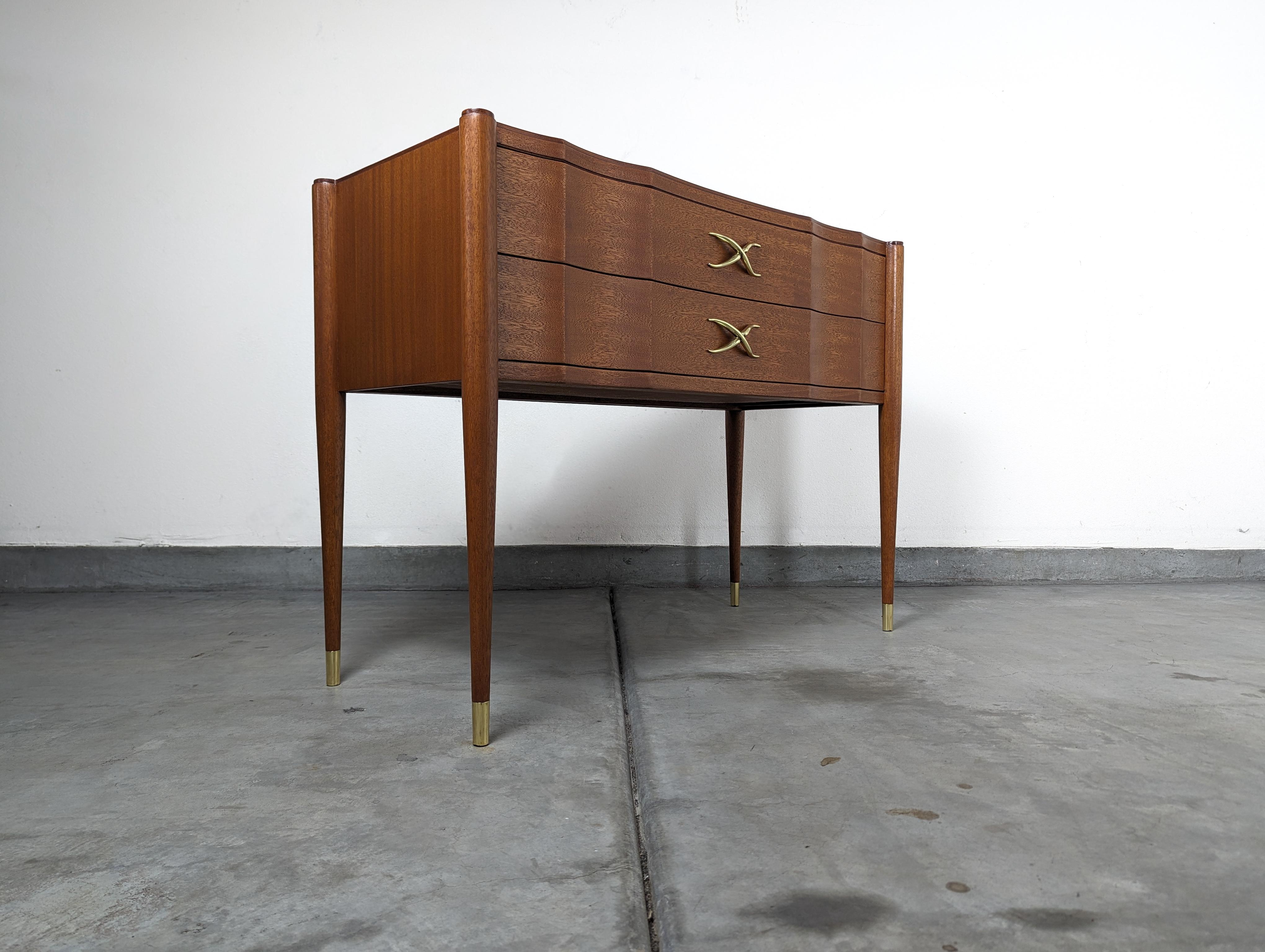 Welcome to a once-in-a-lifetime opportunity to own a piece of mid-century modern history. This stunning Mahogany and Nickel 2-Drawer Console Table, expertly designed by the celebrated designer Paul Frankl , is a showstopper. Known for his