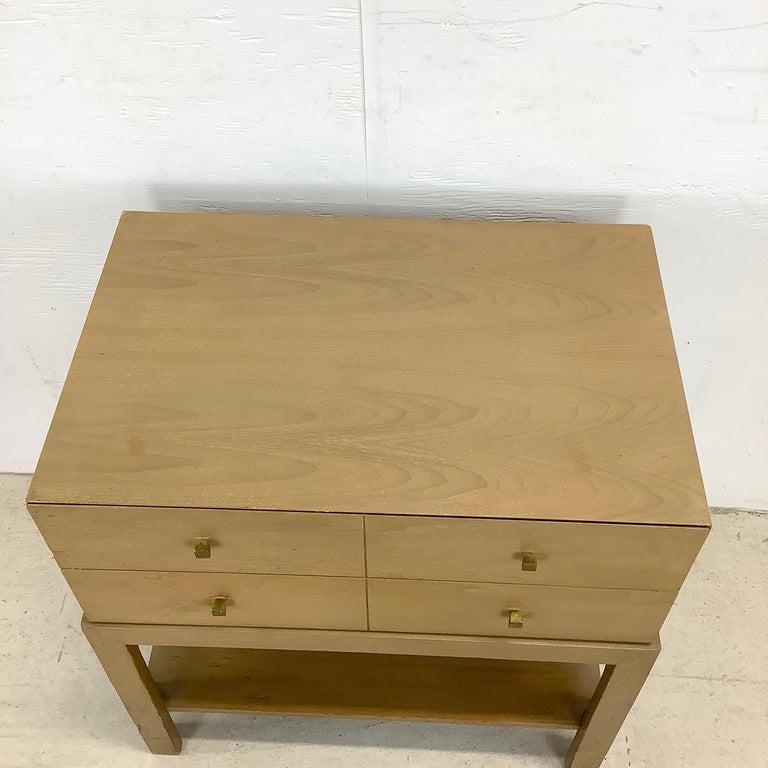 The simple yet striking appeal of this mid-century modern nightstand features clean modern lines, brass finish drawer pulls, and the perfect mix of dual upper drawers and spacious lower shelf perfect for use as bedside table or sofa side table in