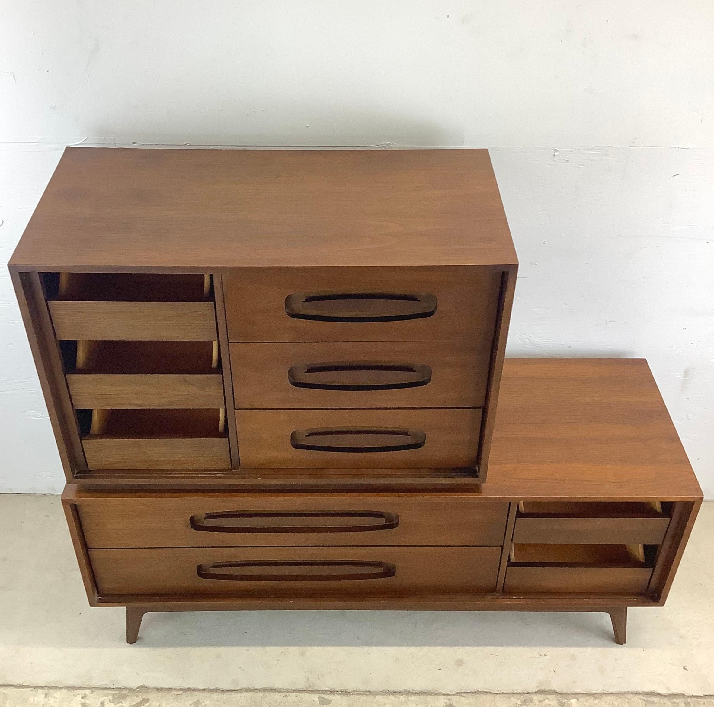 This Mid-Century Two-Piece Chest of Drawers is a stylish storage solution that seamlessly combines form and function. Crafted with the iconic design elements of the mid-century era, this vintage chest of drawers boasts 10 spacious drawers, providing