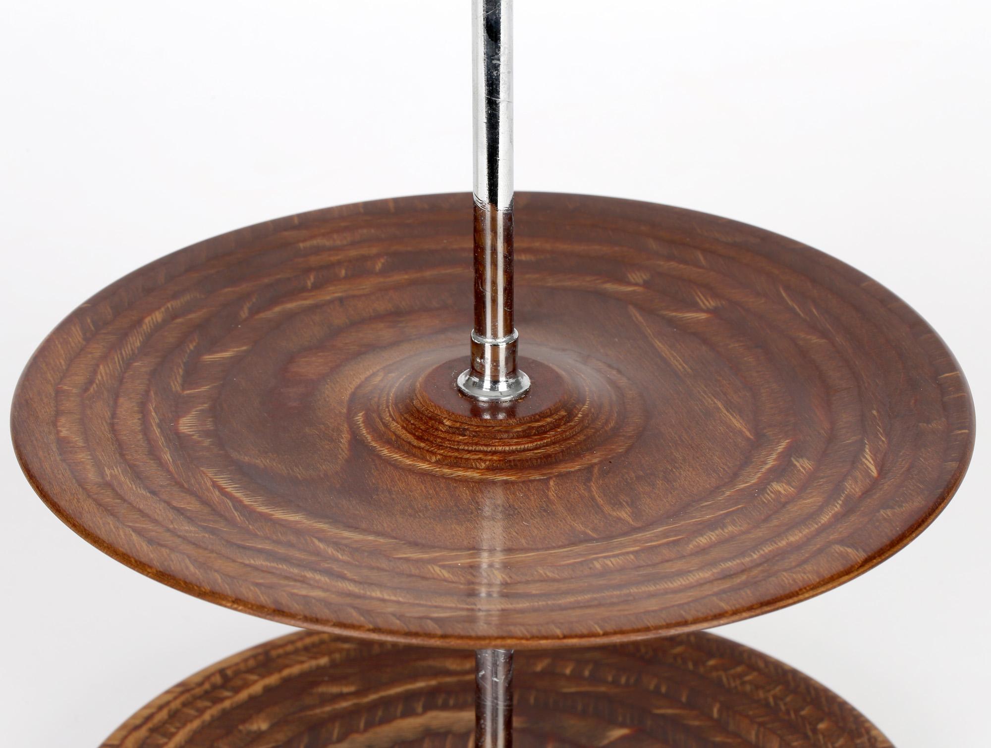 A very stylish quality mid-century, believed British, wood and chrome cake stand dating from around 1960. The cake stand is made from two rounded tiers, probably made from walnut and polished to give an interesting pattern to the grain. The two