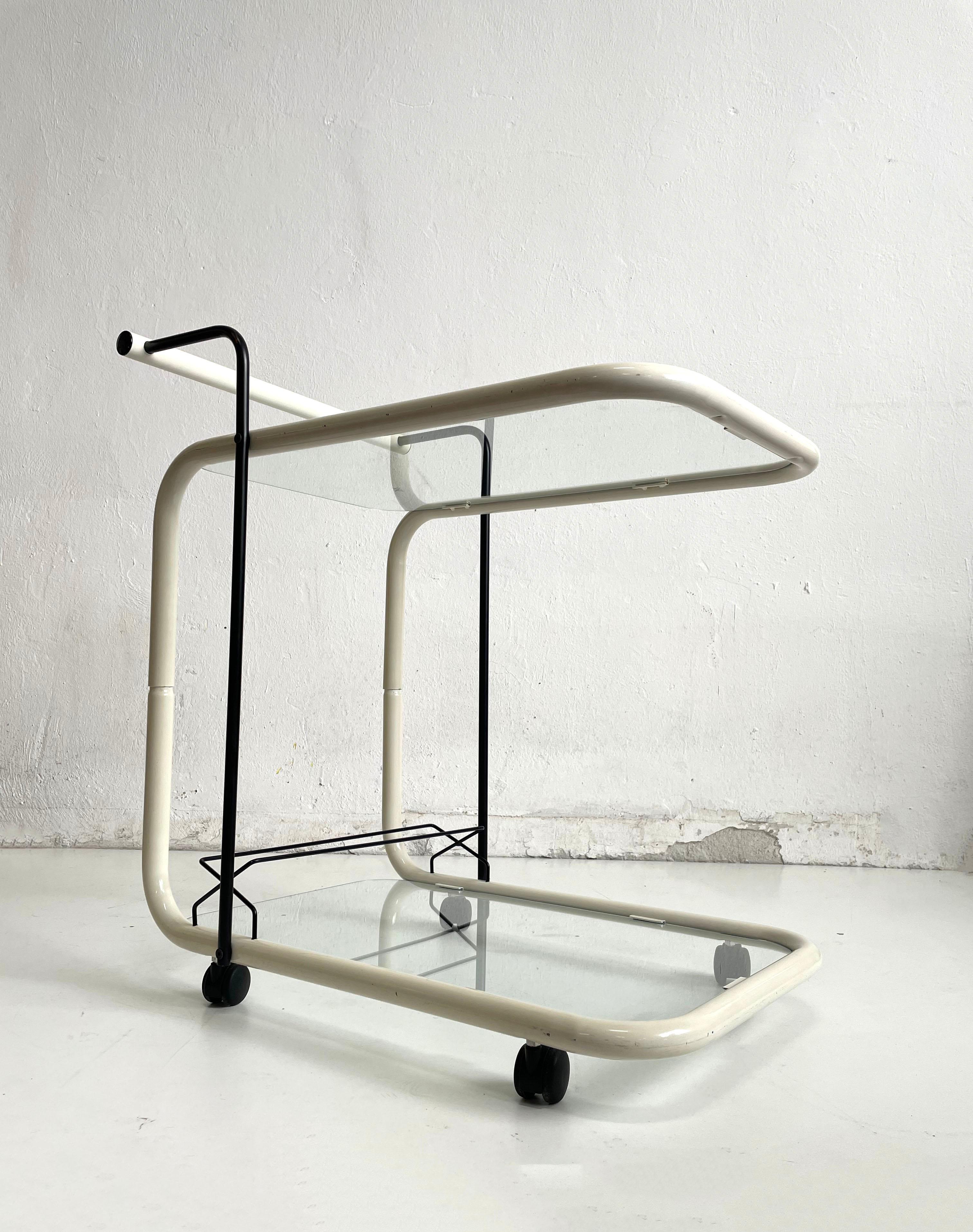 Beautiful modernist Italian designer bar cart from the 1960s or 1970s

Minimalist sculptural, Bauhaus style structure is made of bent metal tubes painted in ivory white colour. The details of the handle and the liquor rack is painted in black.