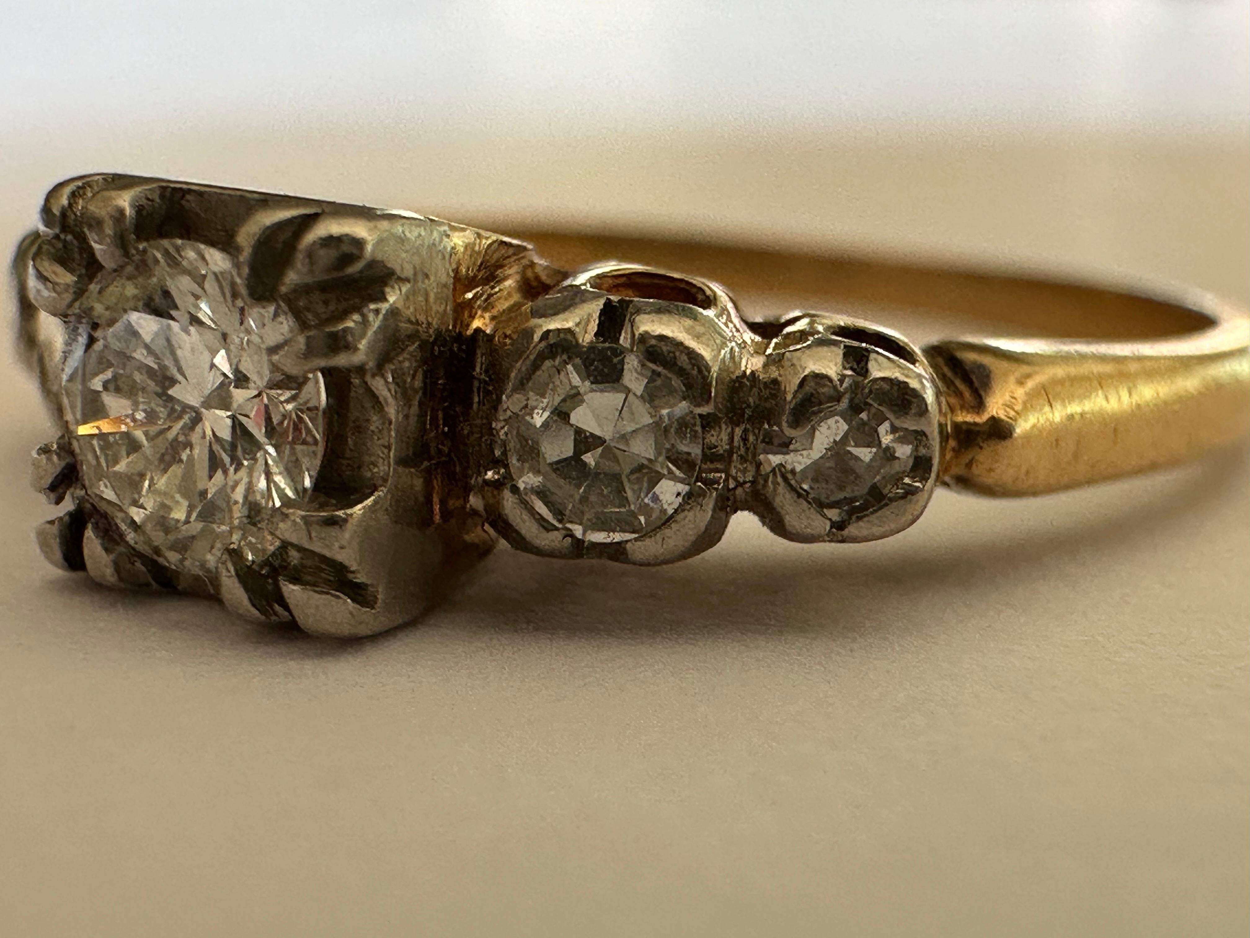 A transitional-cut diamond measuring approximately 0.22 carat, F color SI1 clarity, shines brilliantly at the center of this vintage mid-century ring accented with four single cut diamonds, two on each side. Set in two-tone 14K white and yellow