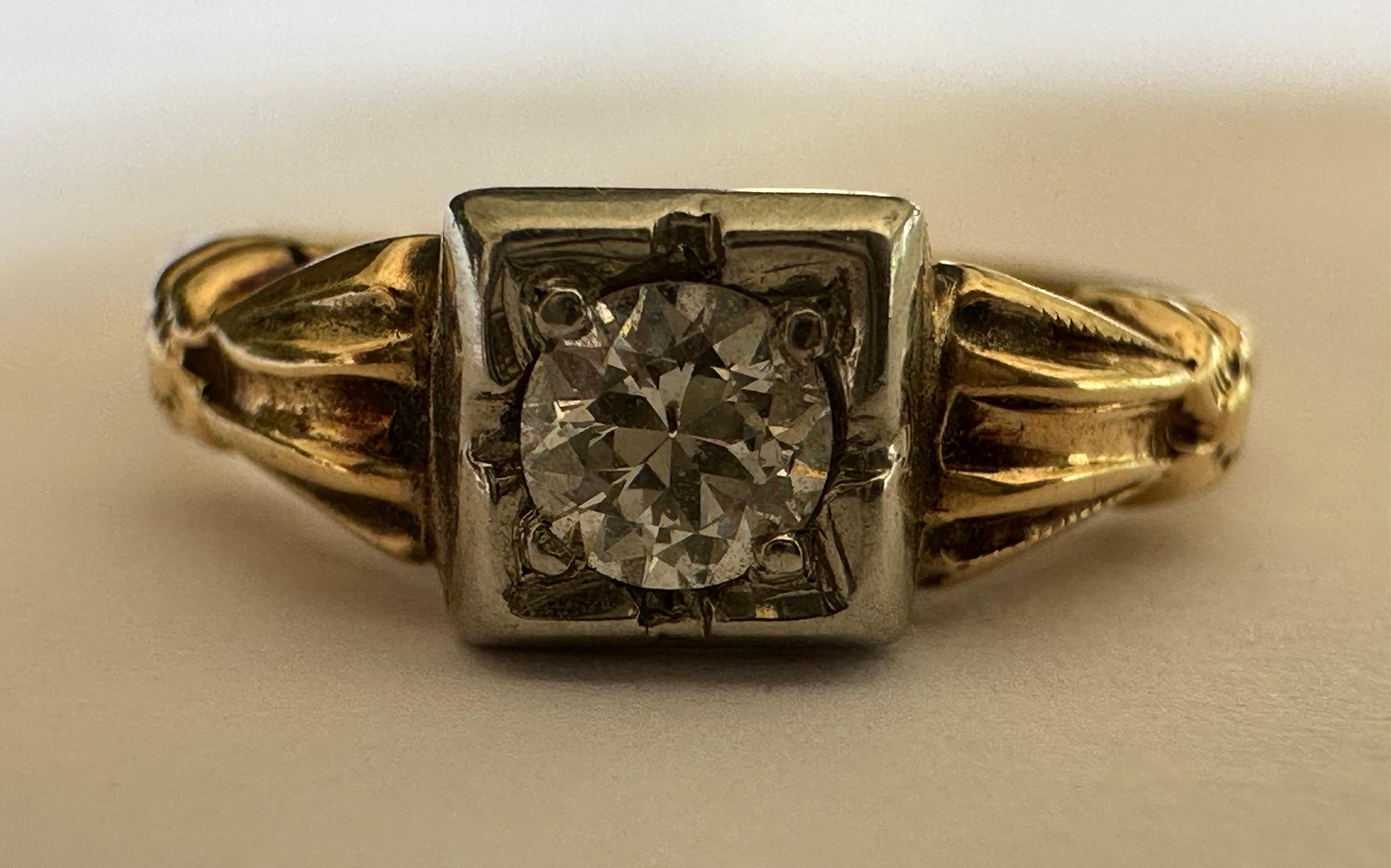An Old European-cut diamond measuring approximately 0.20 carat, G color SI2 clarity, centers this mid-century solitaire band accented with hand engraved details. Set in two-tone 14-18K white and yellow gold. 
