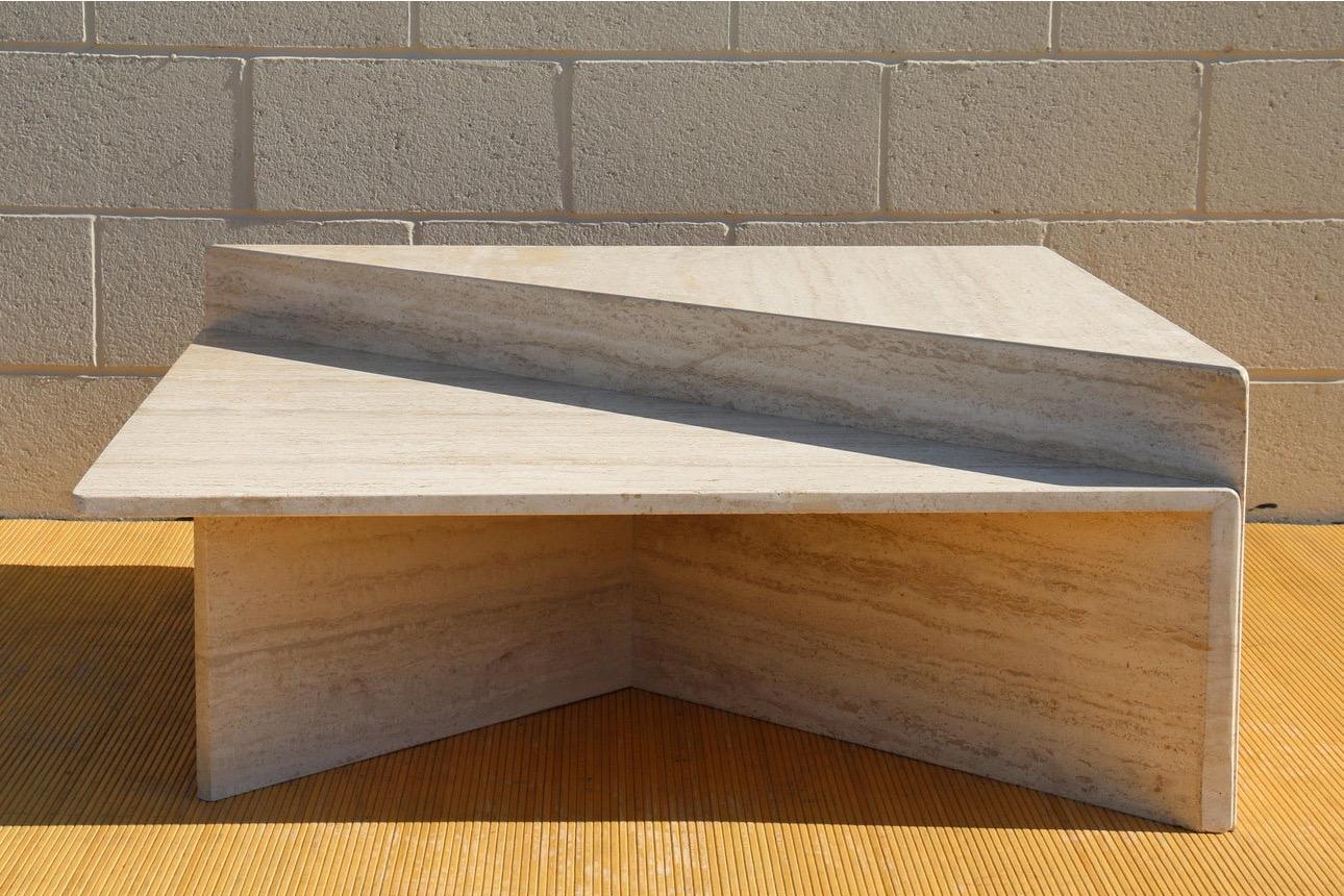 Spectacular Italian two pieces travertine coffee table. From the 1970’s. Such a wonderful design, two triangles with two sides of 39in and one of 56in. They can form a square table of 39” by 39”. The taller triangle is 16in height and the shorter is