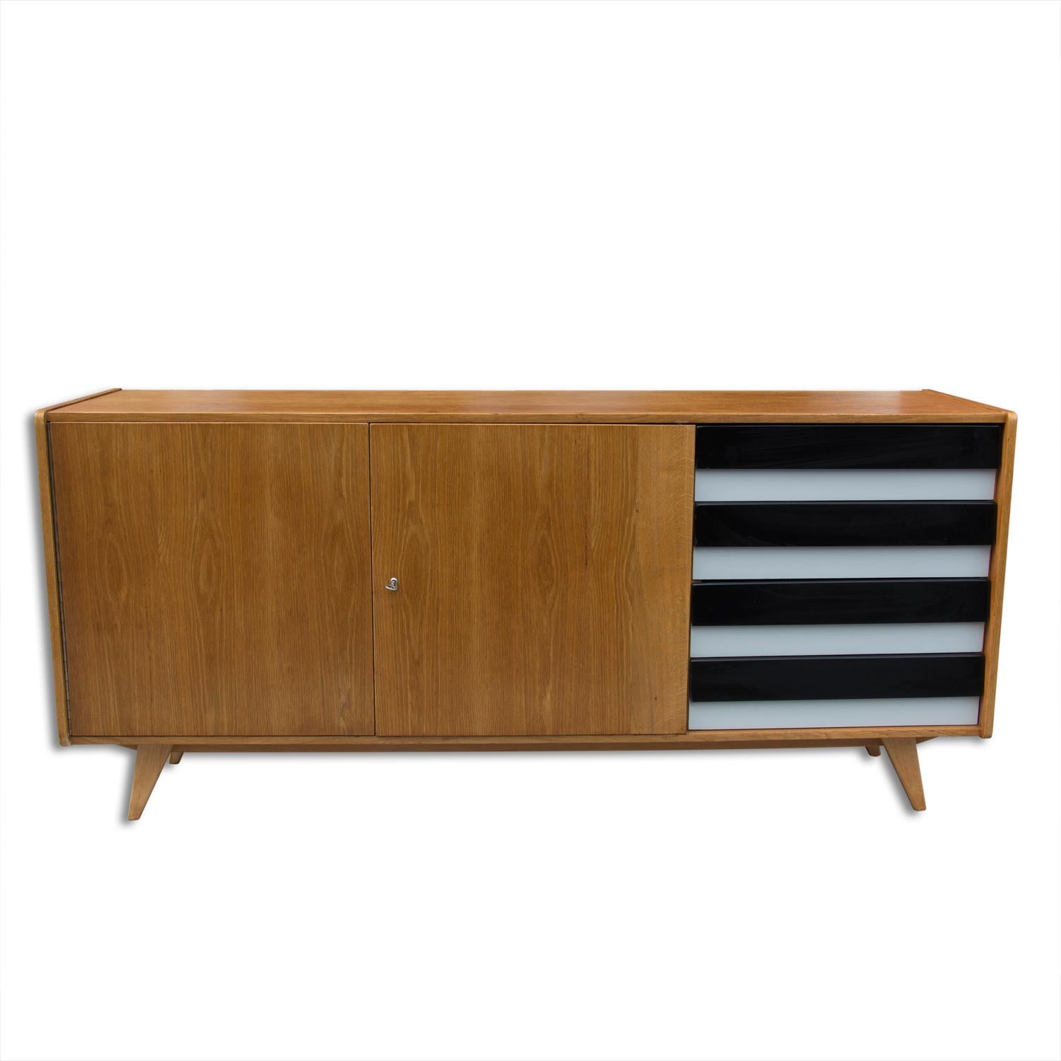 A popular vintage sideboard model U-460 from the 1960´s. It was designed by Jiri Jiroutek for Interier Praha. It features a beech wood, plywood, colored lacquered drawers. In excellent condition, fully refurbished.
  