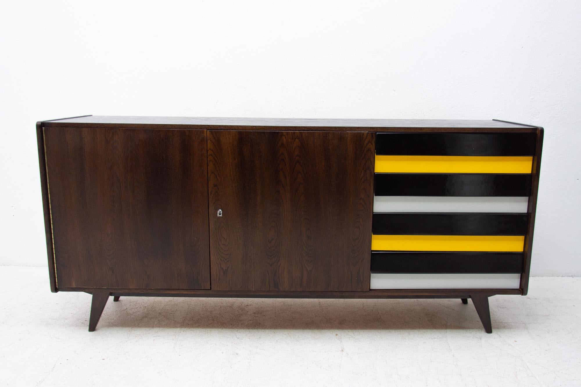 Midcentury sideboard model U-460 designed by Jirí Jiroutek for Interier Praha in the 1960s. It´s made of dark stained oak wood. Features colored lacquered drawers. In excellent condition, fully refurbished.