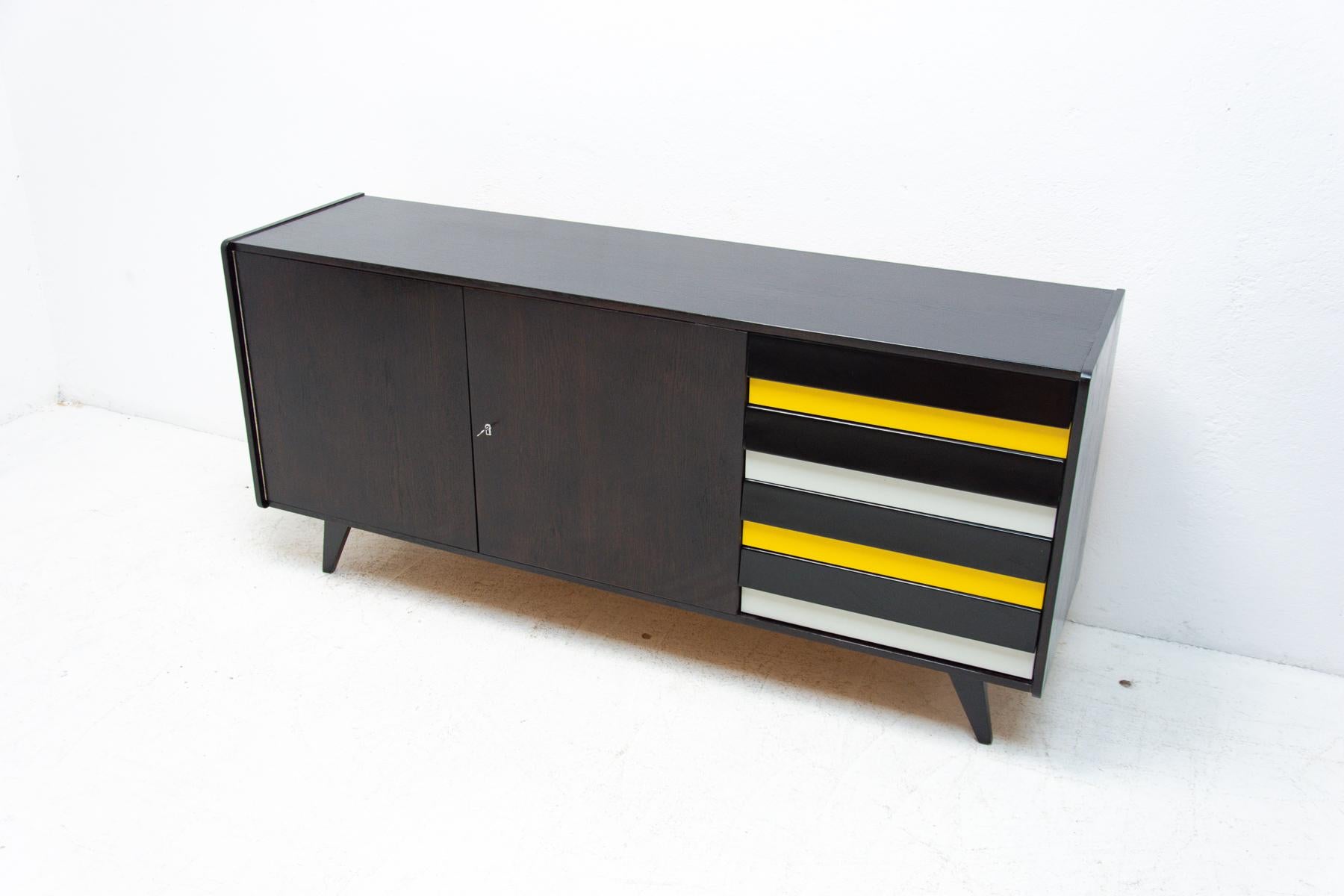 Mid century sideboard model U-460 designed by Jirí Jiroutek for Interier Praha in the 1960´s. It´s made of dark stained oak wood and plywood. Features colored lacquered drawers. In excellent condition, fully refurbished.
 