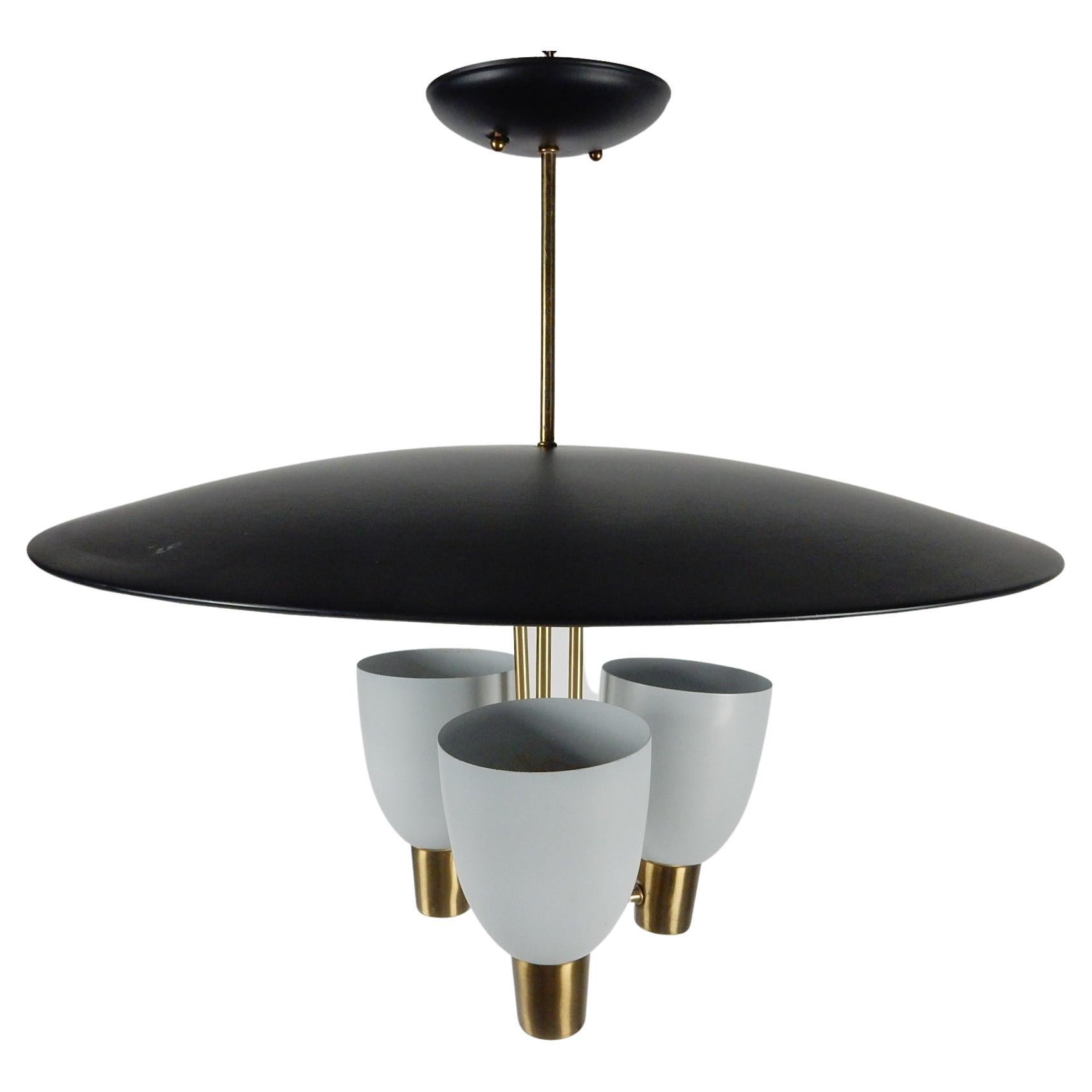 1950's Mid-century UFO saucer diffuser chandelier by Moe Lighting.
Original matte black and putty color enamel with brass plated arms and drop pipe.
Exceptional original condition having hung in the same location since 1953.
Rewired and ready to