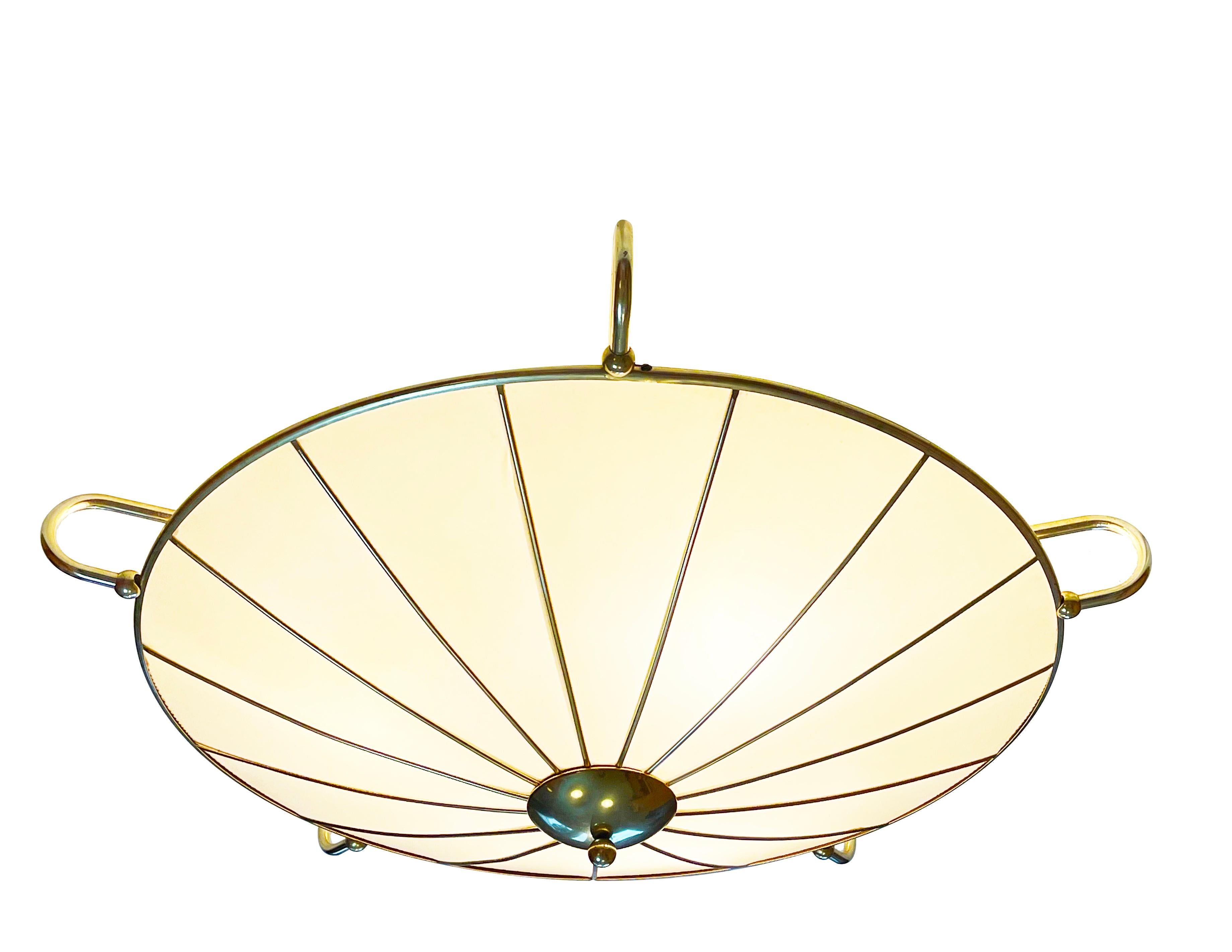 Magnificent, flush base ceiling lamp by 'ERCO Leuchten', one of Germany's famous mid century manufacturer of high-end design lighting.
Comes in a round umrella shape from aluminum with a golden finish. The transparent areas are from a thin elastic
