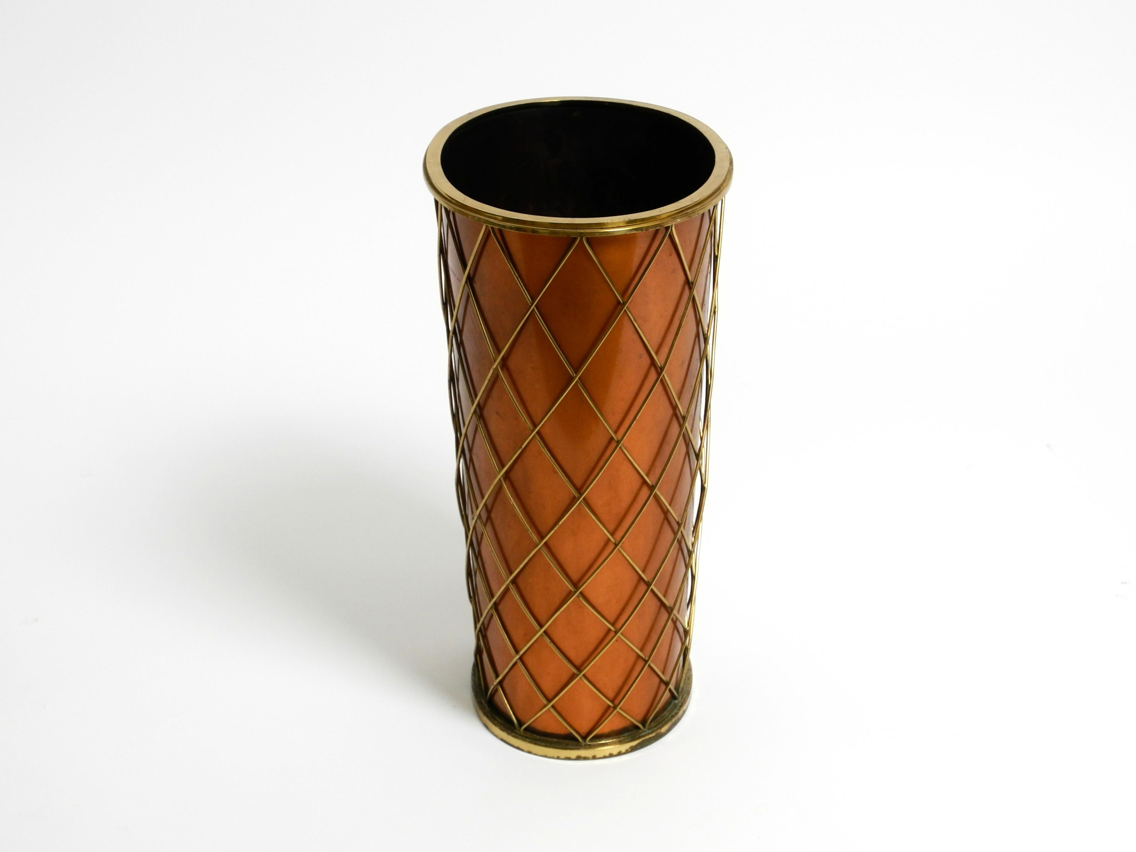 Beautiful large, heavy Mid Century umbrella stand made of copper and brass.
Manufacturer is Vereinigte Werkstätten. Made in Germany. Great design from the golden 1950s.
Umbrella stand made entirely of solid copper. The top and bottom edges and the