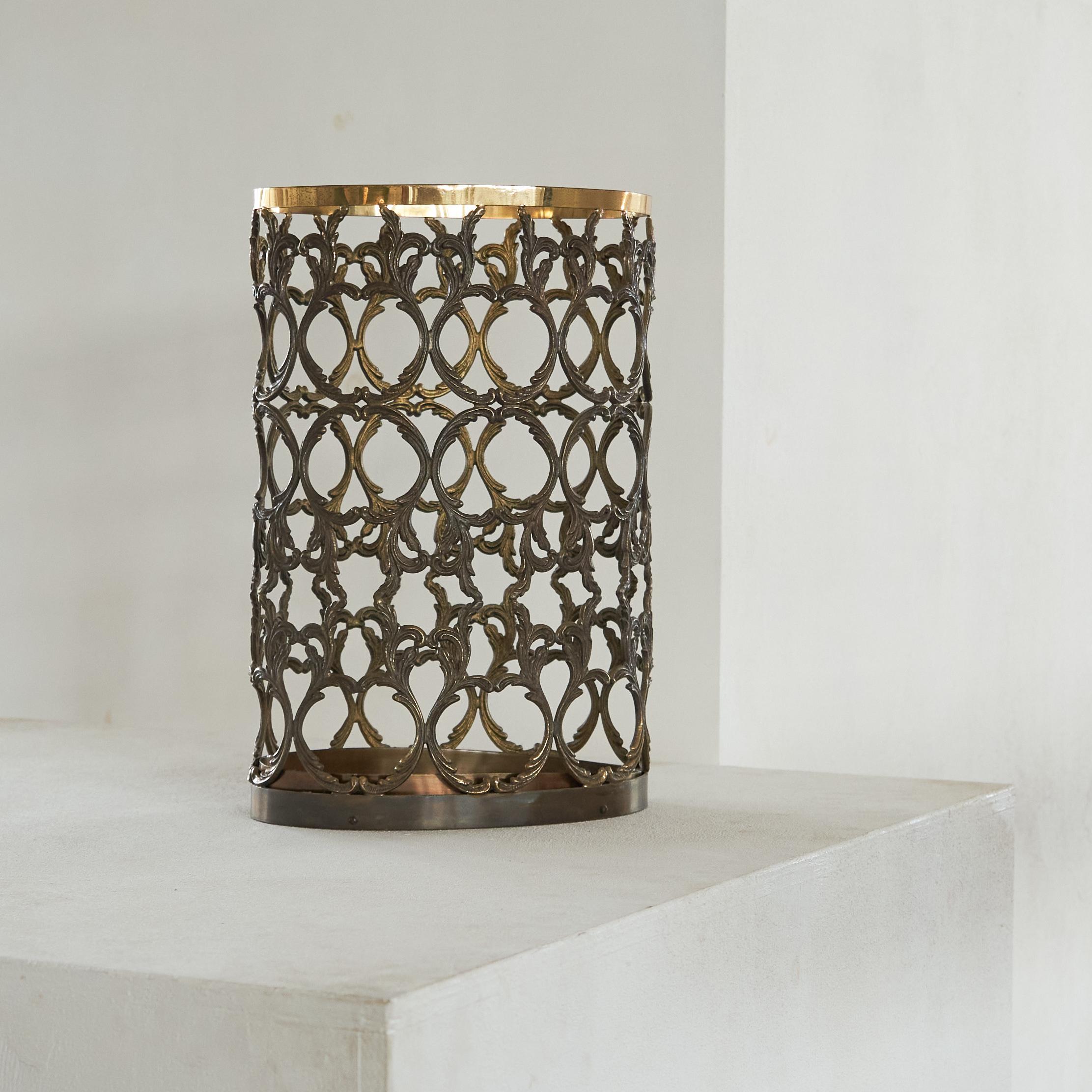 Mid Century Umbrella Stand in Patinated Brass 1960s.

This is a wonderful and very elegant umbrella stand in patinated brass. The main body of the umbrella stand is constructed out of a floral pattern made in solid brass, completed with a shiny ring