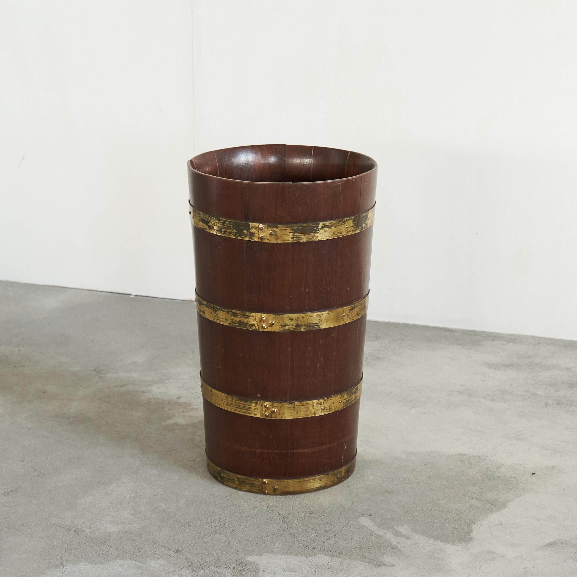 Mid Century Umbrella Stand in Solid Wood and Patinated Brass, 1950s.

This is a wonderful and large umbrella stand in solid wood and patinated brass rings. Probably French and from the 1950s. Great wood color and beautiful patinated brass rings all