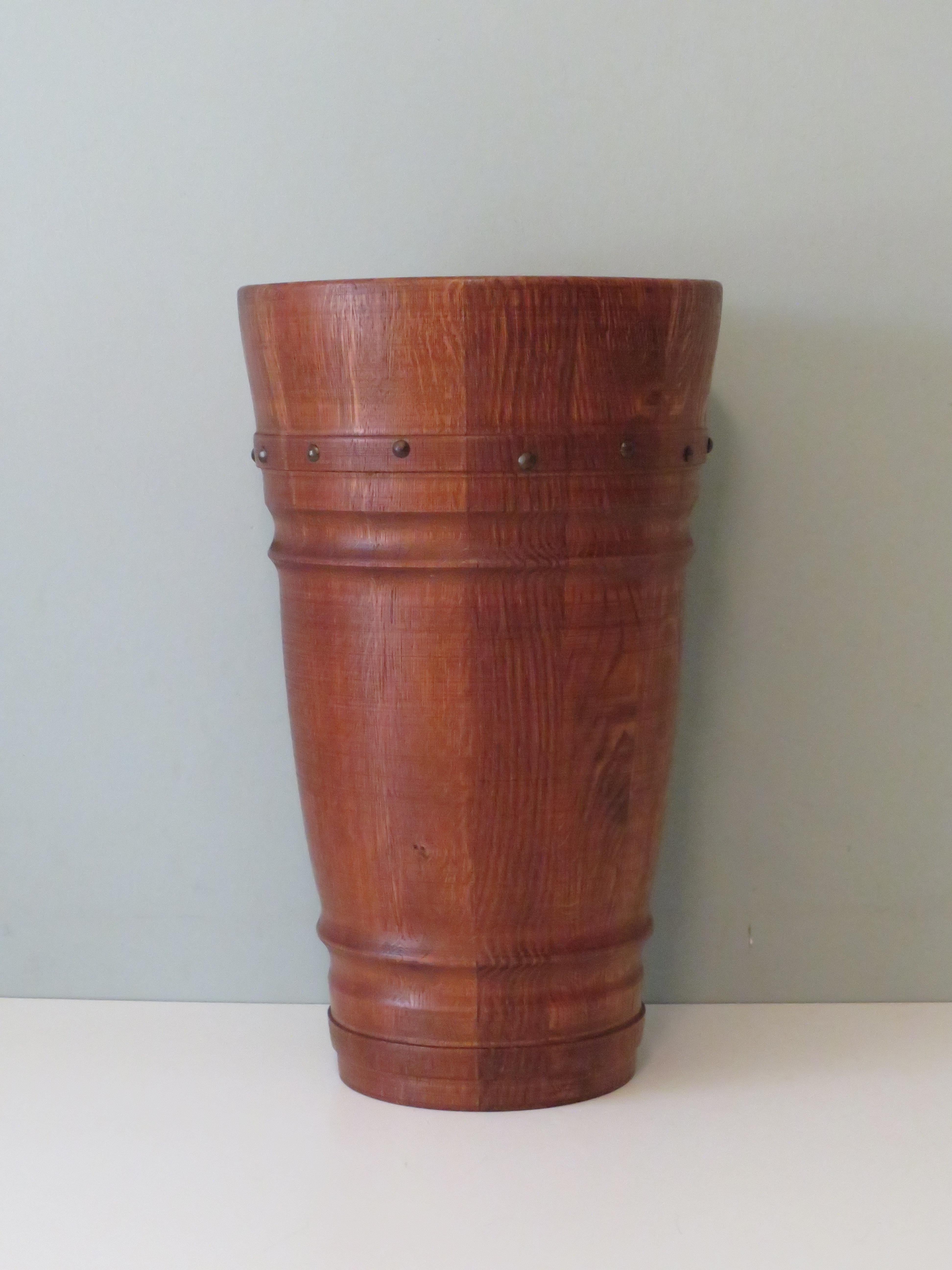 Porte-parapluies rond en bois massif, fini avec des clous métalliques.
Hauteur : 46 cm et diamètre en bas : 17.5 cm et diamètre au sommet : 27,5 cm.
Le porte-parapluie est en bon état.