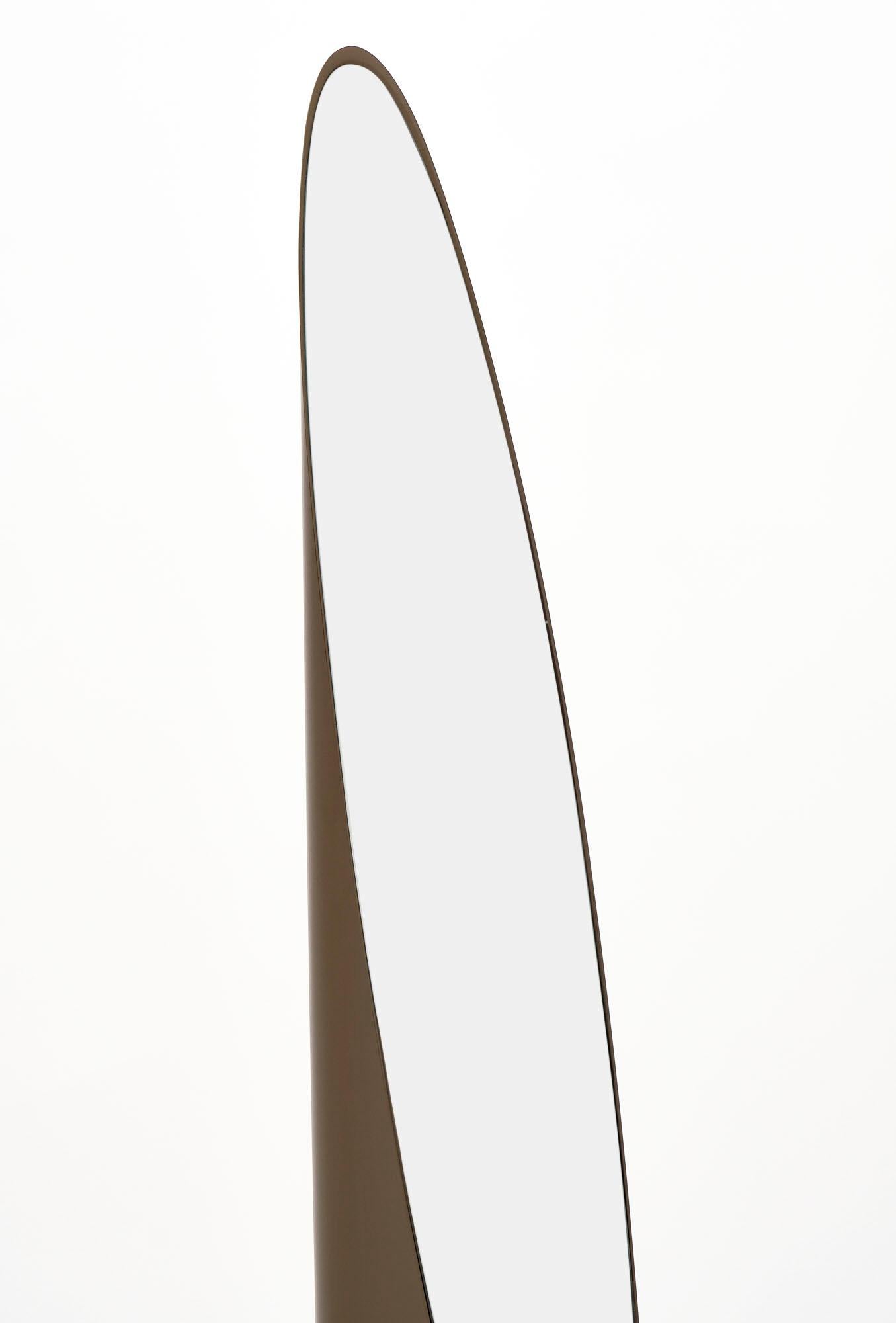 Unghia mirror designed by Rodolfo Bonetto. This piece is Italian. Unghia means “nail” in Italian; though the mirror is also referred to as a “lipstick” mirror. This piece would look great in your space age; modern; or eclectic room.