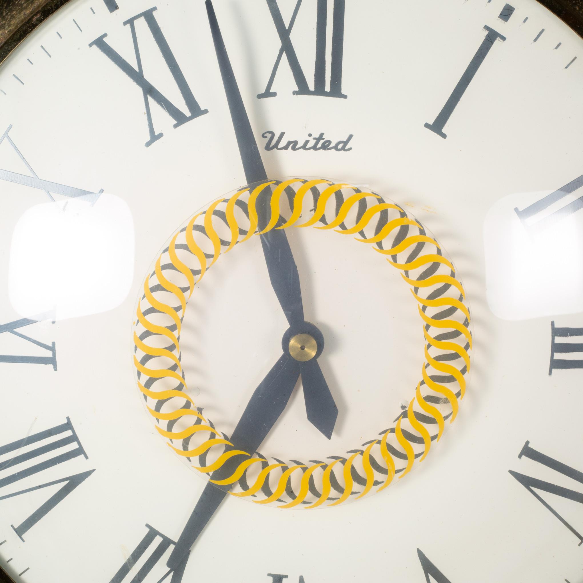 ABOUT

An original United Clock Corp. oversize brass pocket watch hanging clock. The clock features a white clock face with black lettering, curved glass front, gold glass accents long brass chain and plug in cord. Marked 