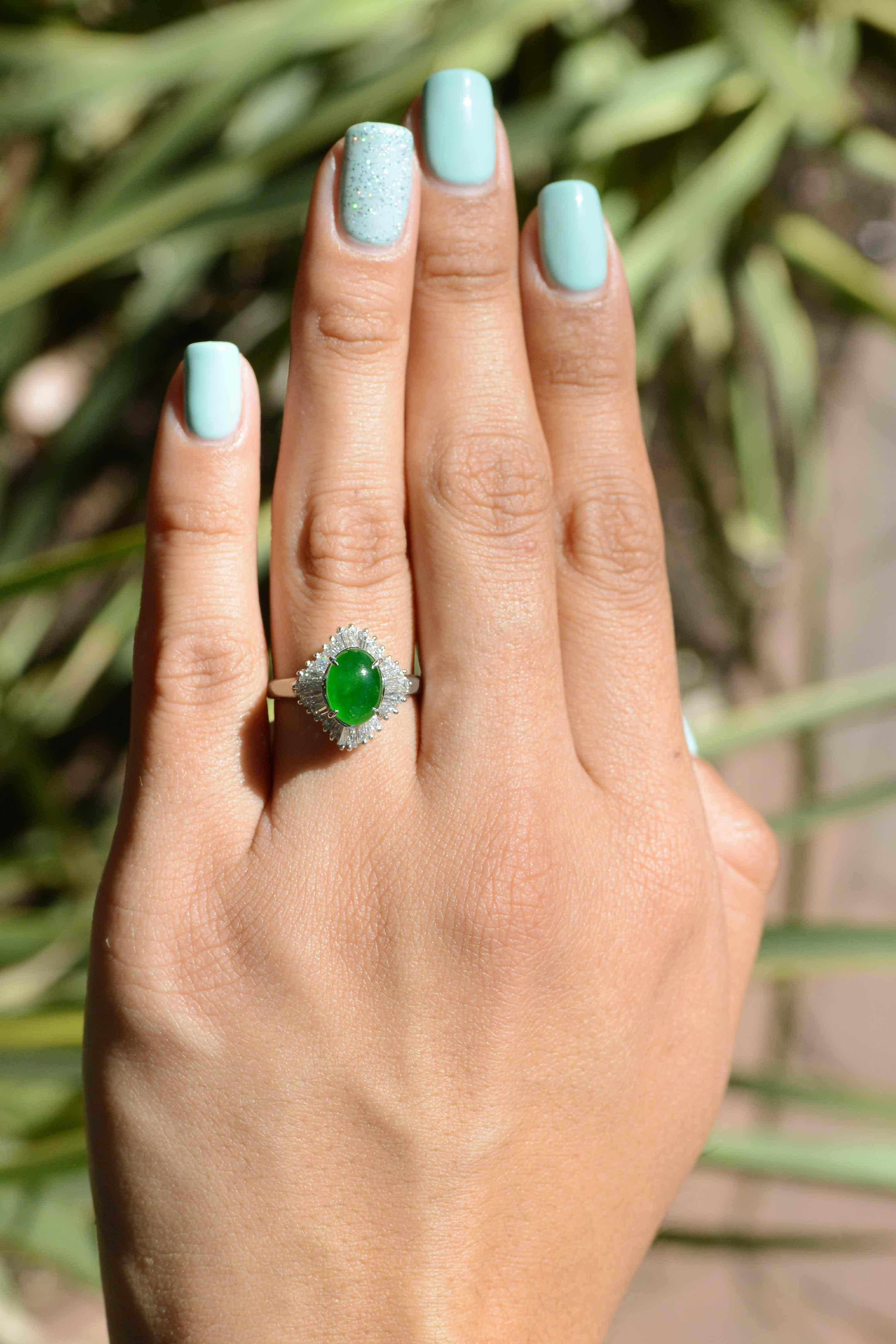 This mid century ballerina ring is an eye catching piece. This untreated, Type A  imperial jadeite has a deep, inviting, pure green color, set on a pillow of baguette diamonds that taper out from underneath it. This rare treasure is a