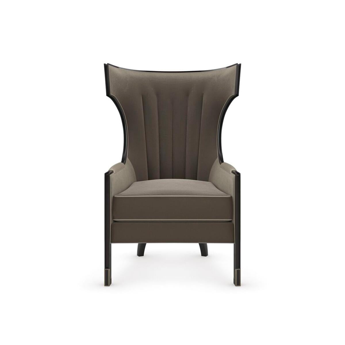 Mid-Century Updated Wingchair, a contemporary take on the classic wing chair. Beckoning in a lush pewter velvet with channeled seams along the back, it features a shapely, slender wood frame in Almost Black, accentuated by padded armrests and welt