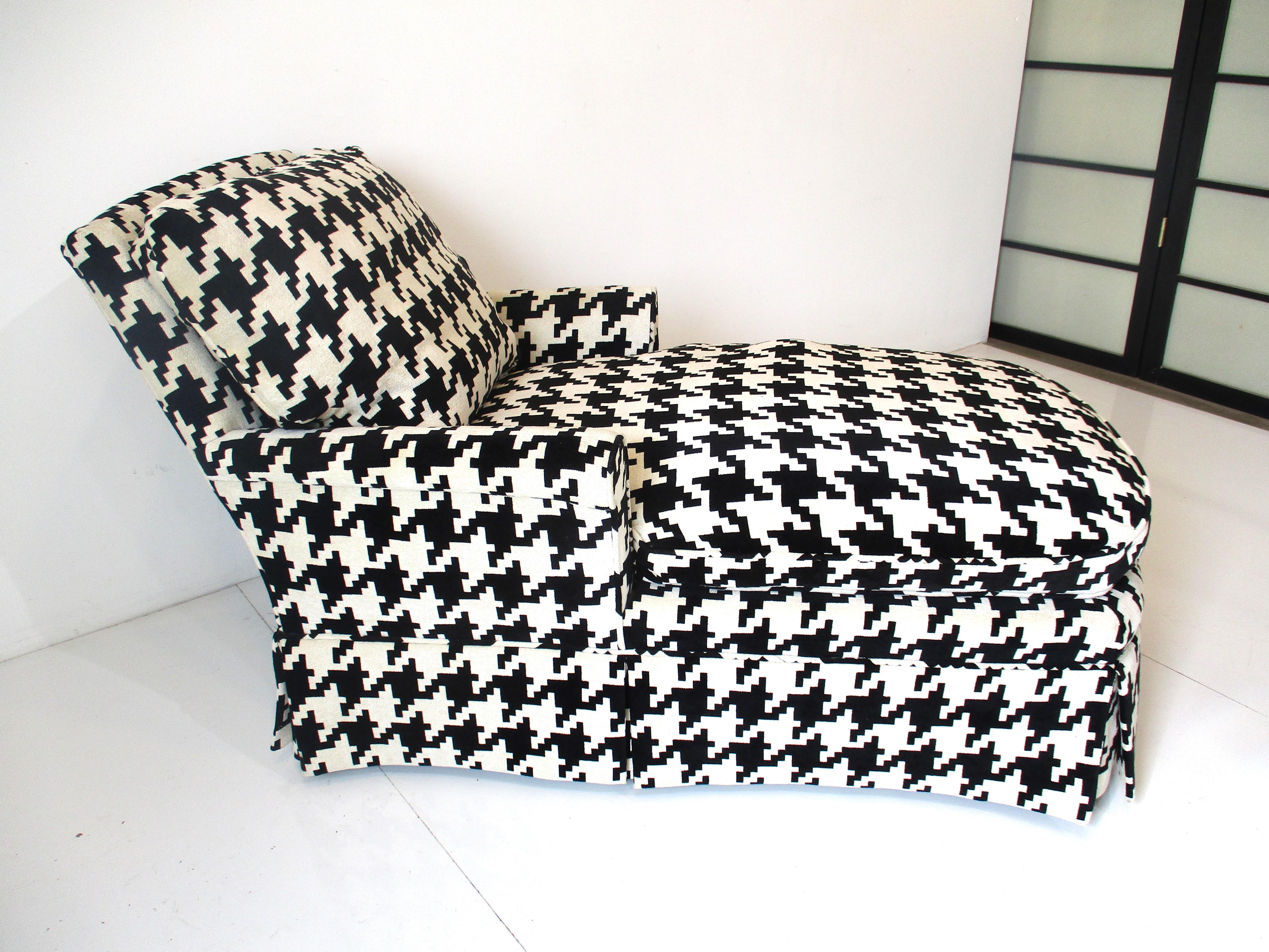 A very well upholstered chaise lounge chair in a Kravet luxury houndstooth soft feder chenlle weave fabric in a bold modern black and white. Super comfortable having a separate back and long bottom cushion both down filled and arms at the perfect