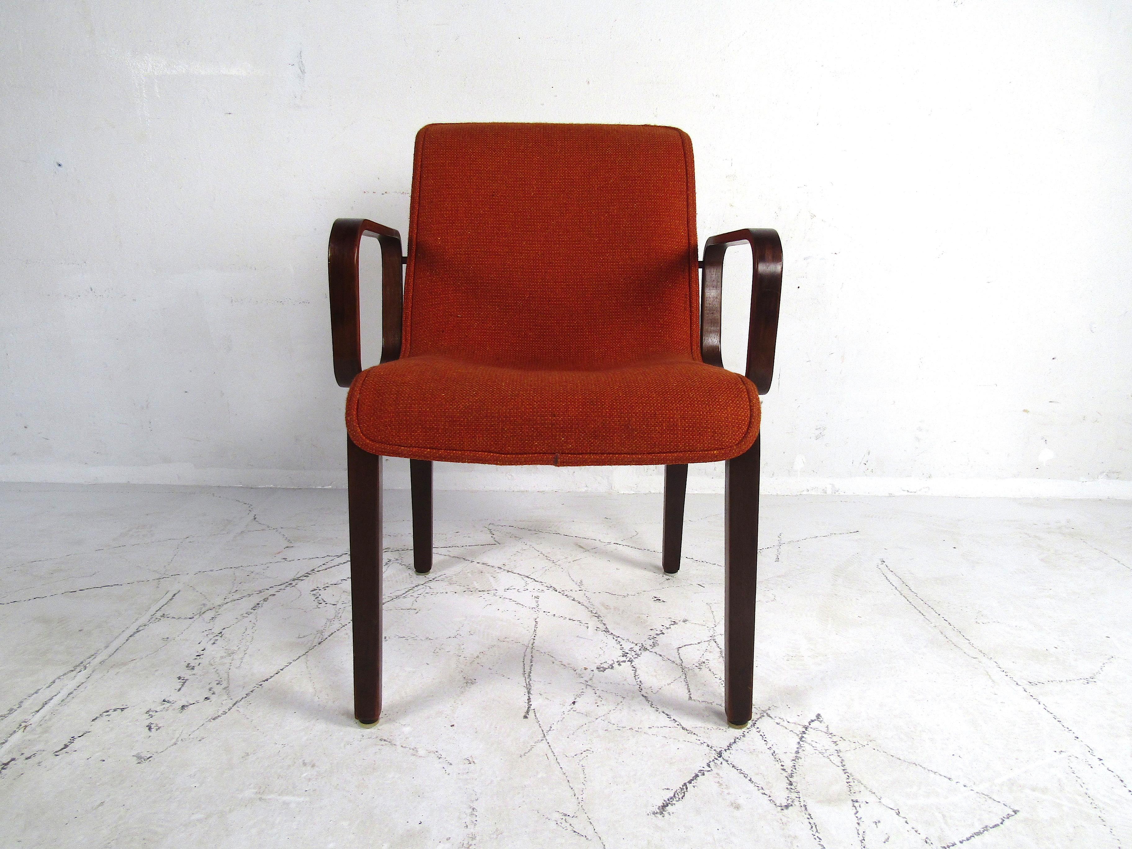 A stylish set of 4 midcentury upholstered dining chairs. Bentwood frames with interestingly contoured armrests on each chair. Seats and backs are covered in a vintage orange upholstery. This set is sure to provide a great seating solution to any
