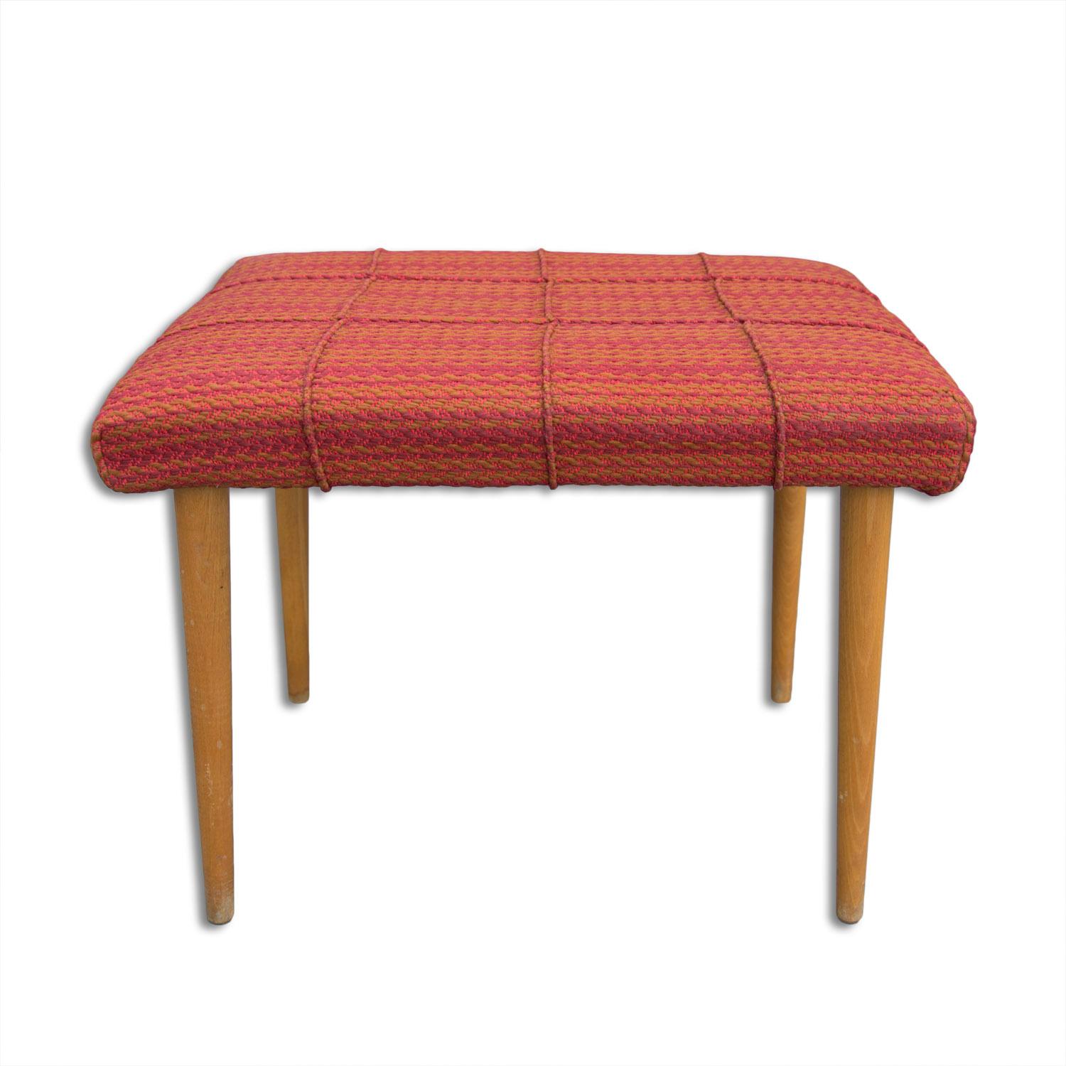 This stool/footrest was made in the former Czechoslovakia in the 1960´s.

It´s made of beech wood and it´s upholstered in fabric. In good condition, shows slight signs of age and using.
 