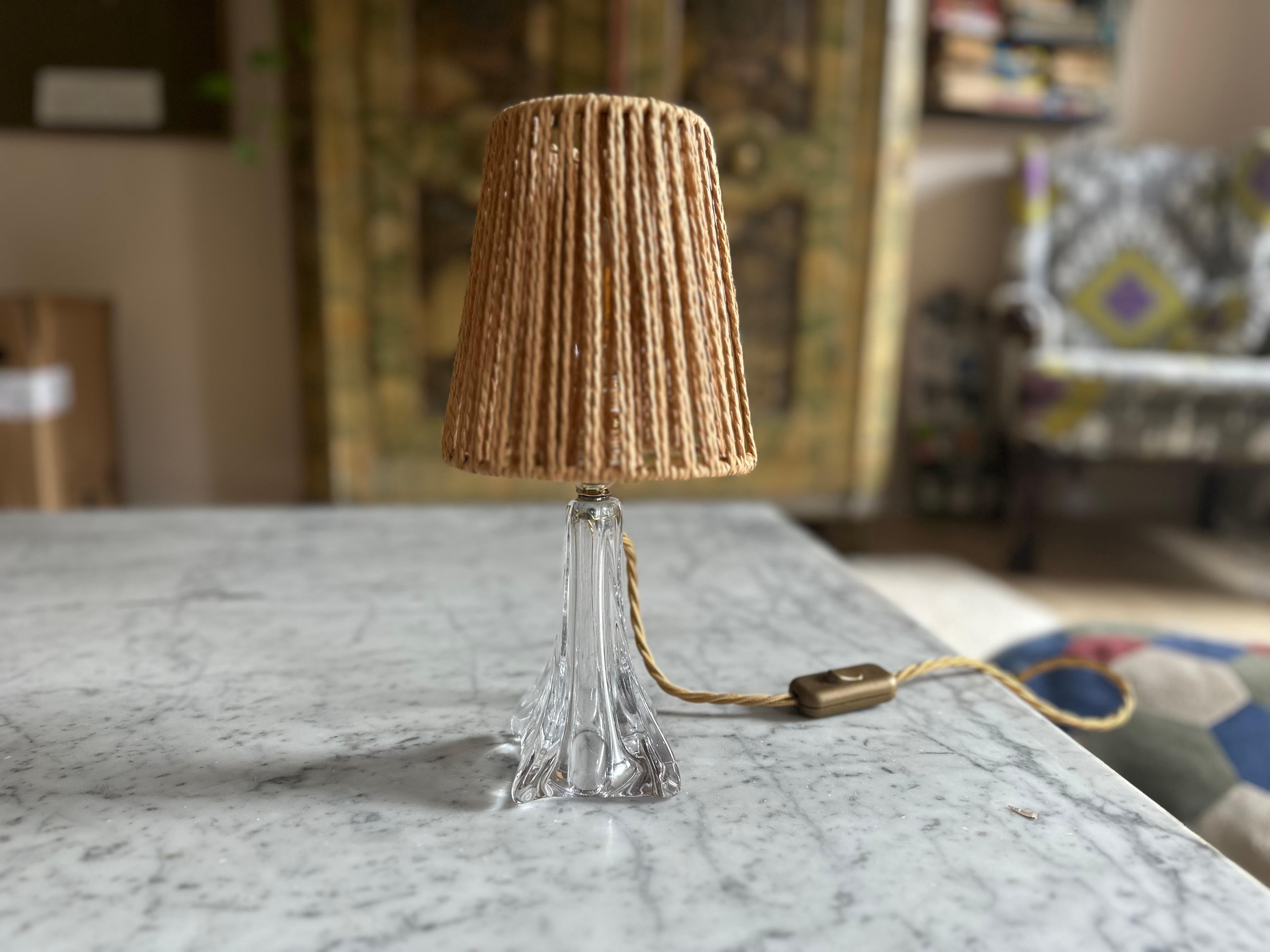 This striking mid-century table lamp was made by Val Saint Lambert, the celebrated Belgian glass manufacturer known for its exceptional craftsmanship. Dating from the 1950s, the lamp features a beautifully clear, solid glass base with no hollow
