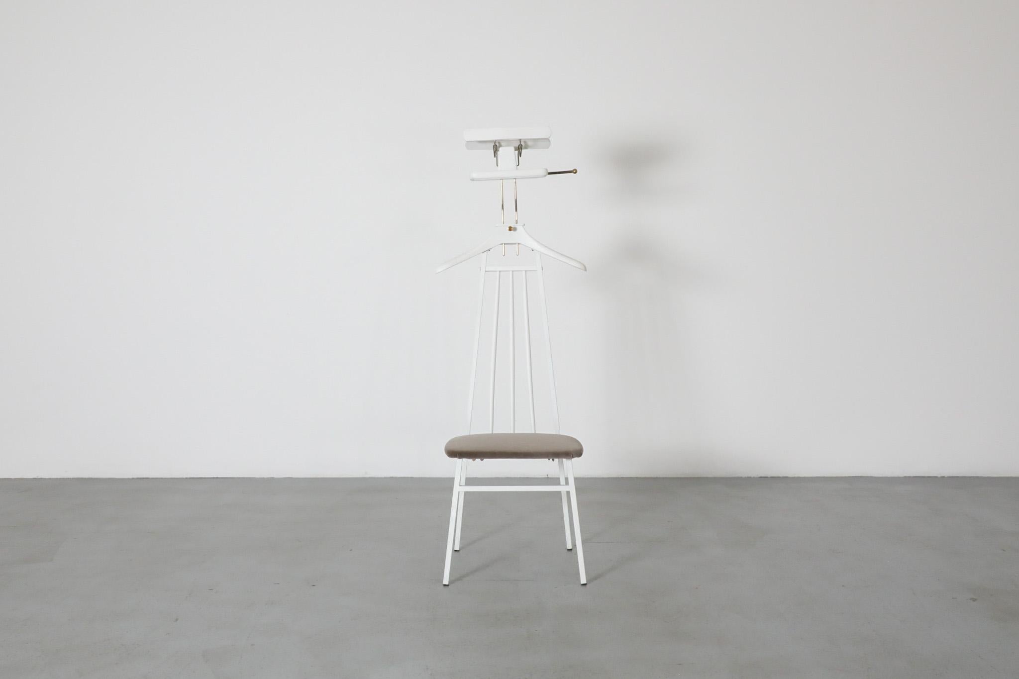 Unique, Mid-Century, 1960s valet or butlers chair with newly painted white wood frame, new grey velvet upholstered seat, and brass hardware. In original condition with visible patina and wear consistent with its age and use.