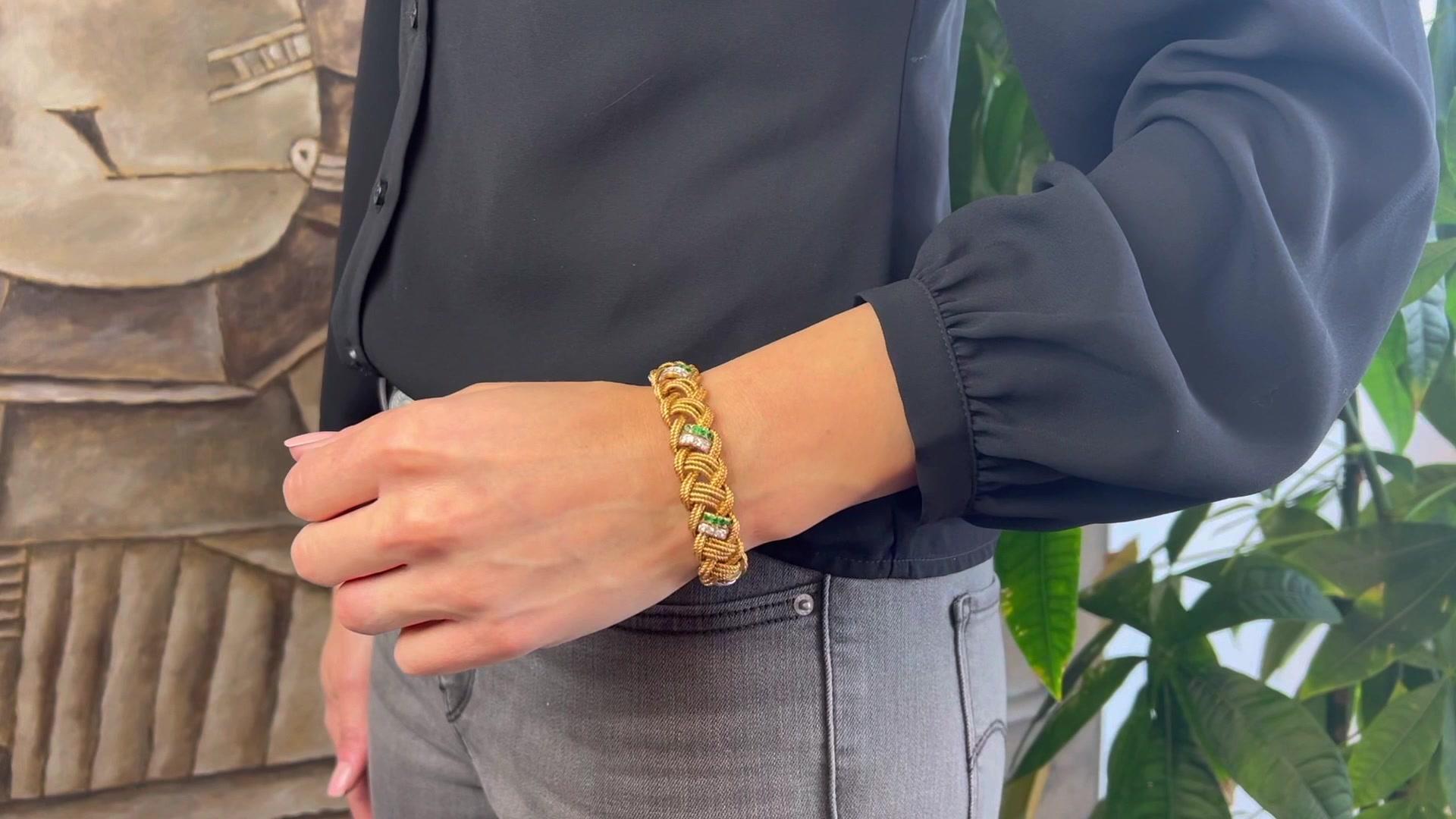 One Mid Century Van Cleef & Arpels Diamond Emerald 18k Yellow Gold Braided Rope Bracelet. Featuring 28 round brilliant cut diamonds with a total weight of approximately 1.30 carats, graded D-E color, VVS clarity. Accented by 28 round brilliant cut