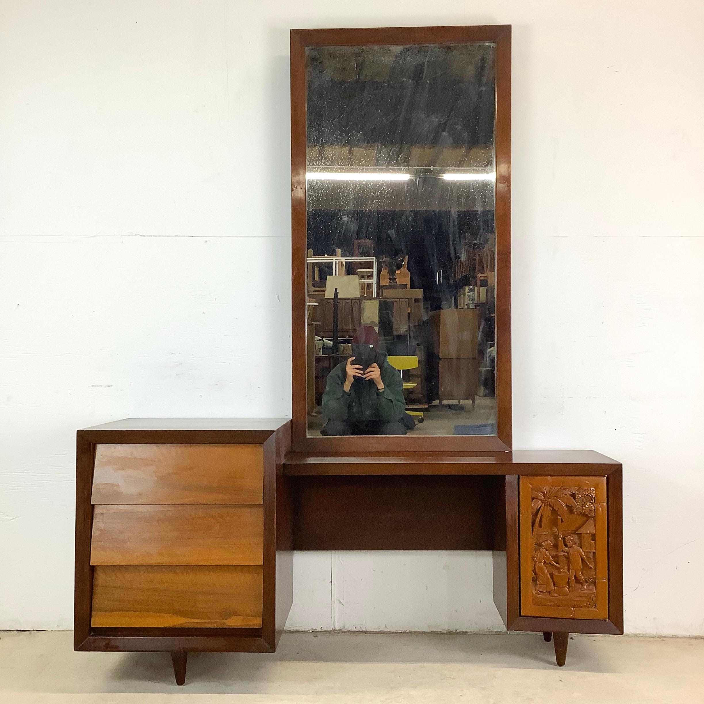 Sophisticated yet full of character, this mid-century Italian vanity blends classic mid-century modern design with handcrafted tropical carved details, creating a truly unique statement piece. Featuring a large mirror, sculptural cabinet, drawers,
