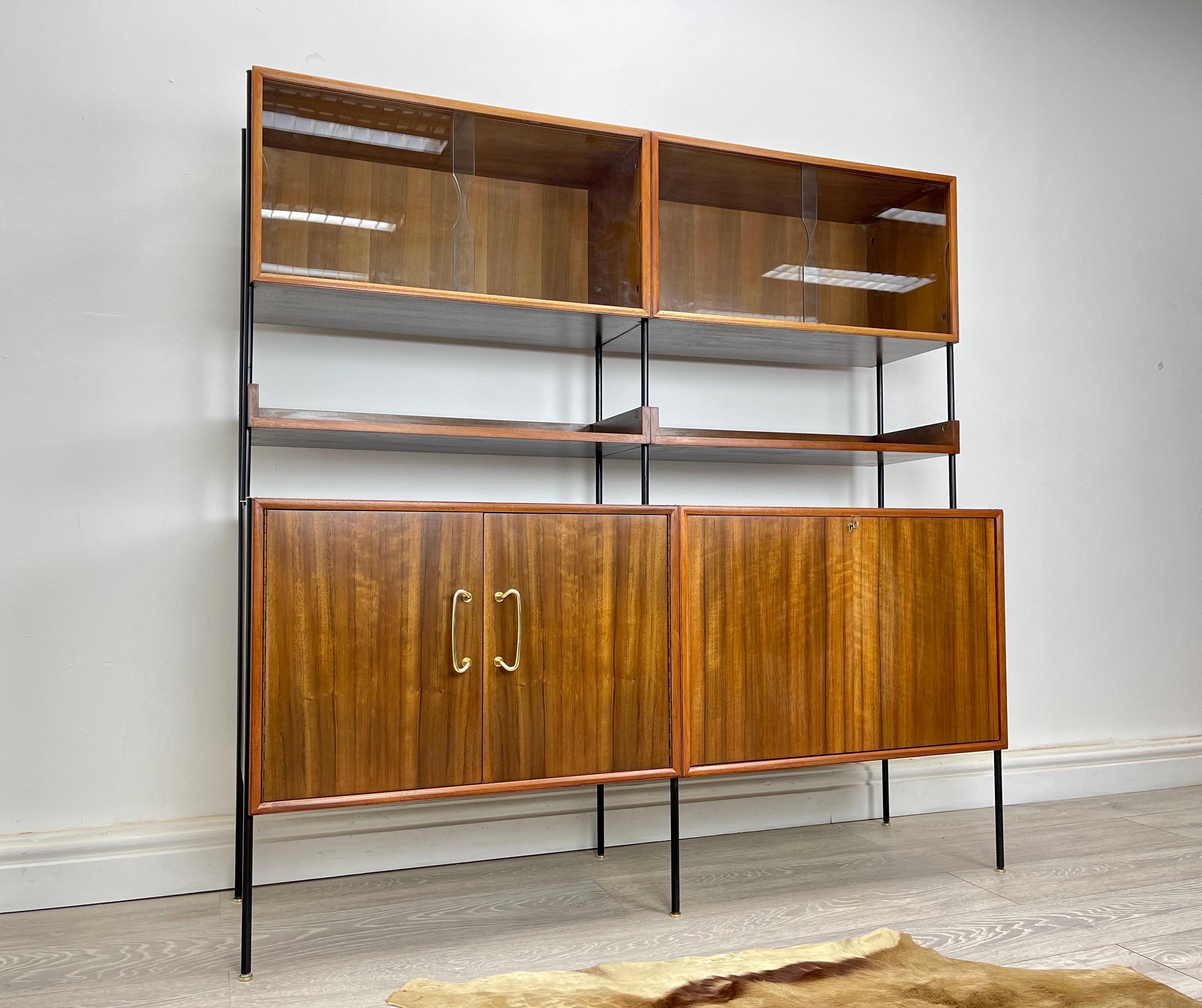 Shelving Unit
Stunning Vintage Walnut shelving system designed by peter Hayward for Vanson furniture cir 1950s . The shelving system stands on satin black metal frame with stunning walnut veneer throughout and brass fittings great quality piece