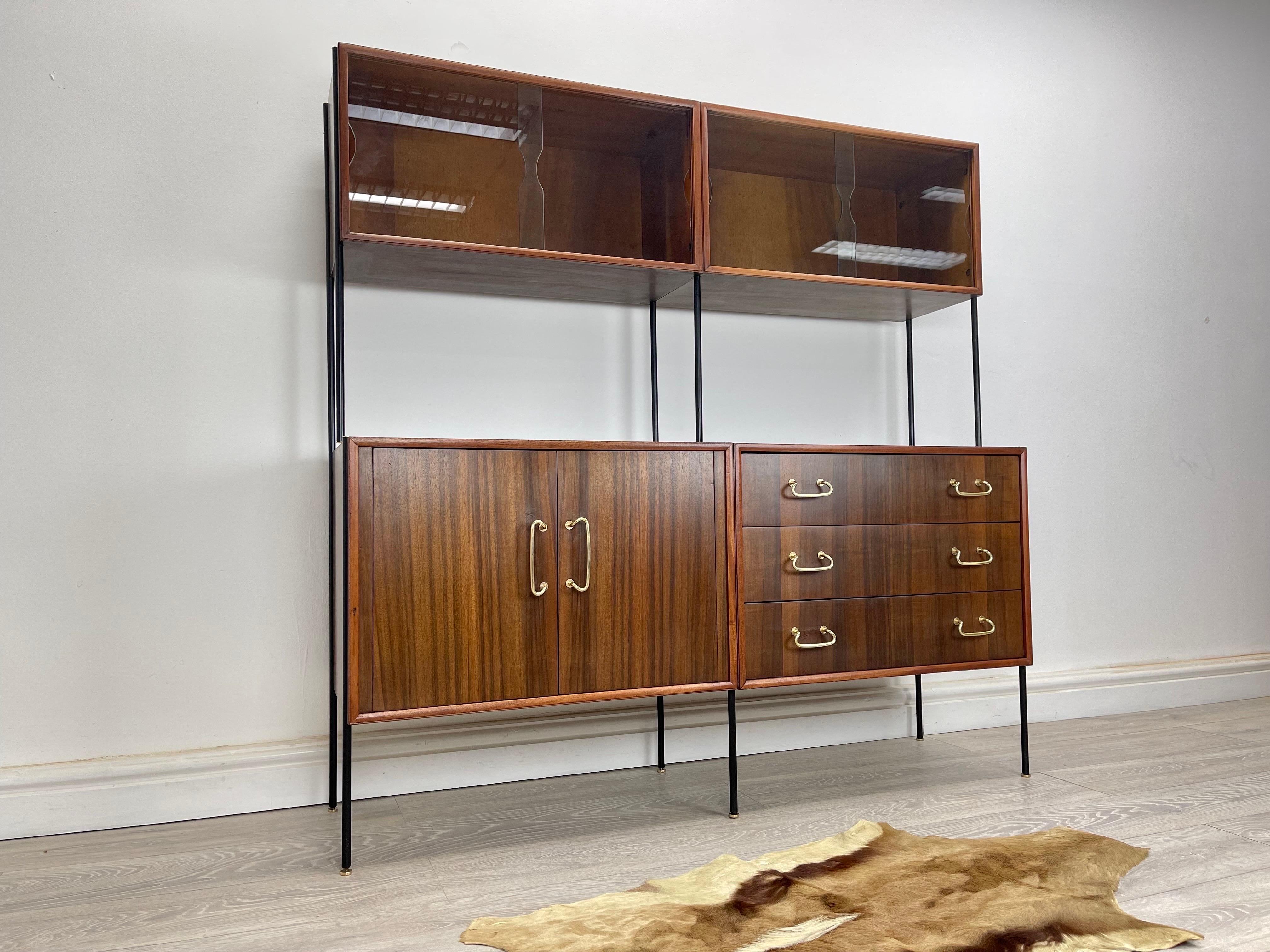Shelving Unit
Stunning Vintage Walnut shelving system designed by peter Hayward for Vanson furniture cir 1950s . The shelving system stands on satin black metal frame with stunning walnut veneer throughout and brass fittings great quality piece