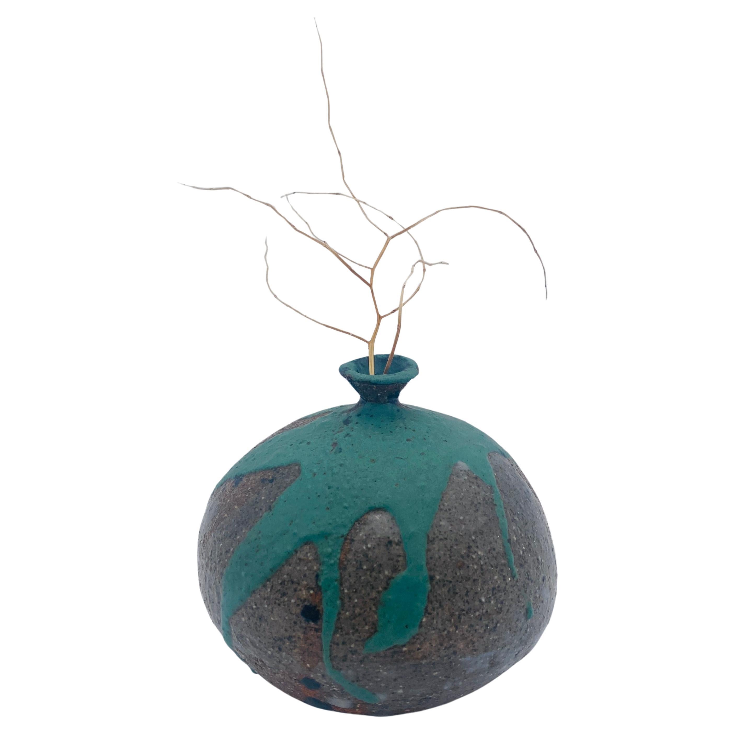 This mid-century vase is an excellent representation of California studio pottery from the 1960s. This weed pot is signed 