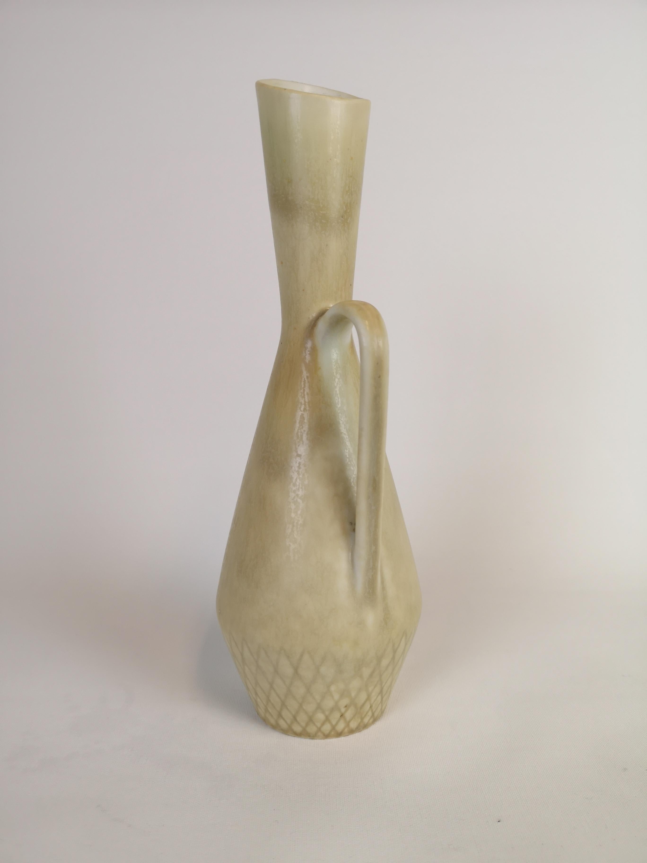 Nicely sculptured vase with glaze that shifts in colors. 
Made in Sweden at Rörstrand factory and designed by C-H Stålhane. 

Very nice condition. 

Measure: H 27 cm, D 10 cm.
 