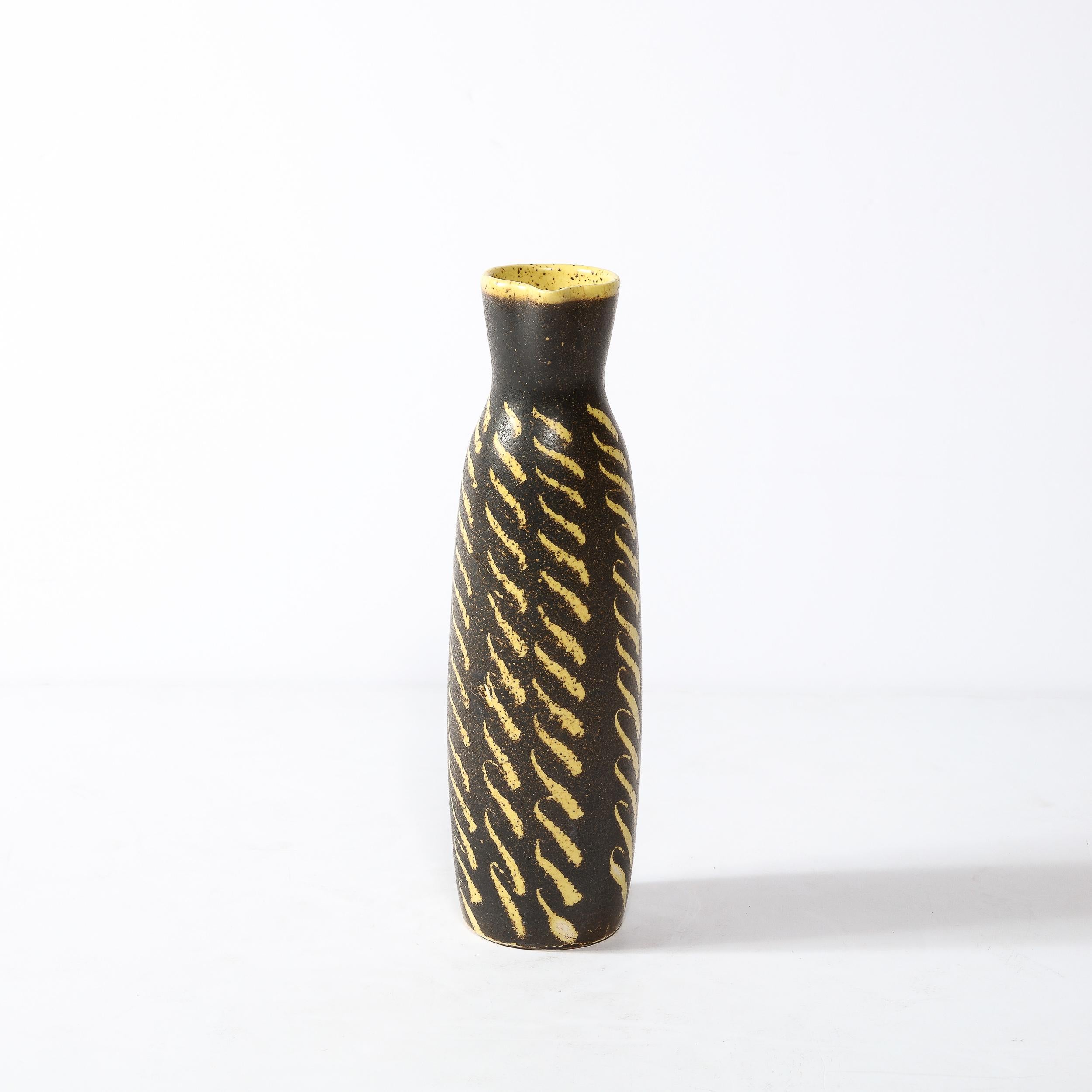 -This boldly patterned Mid-Century Modernist Ceramic Vase Originates from the United States, Circa 1960. The body of the vase curves gently outwards with a hand-brushed patterning in  yellow and burnt umber glaze creating vibrating movement and