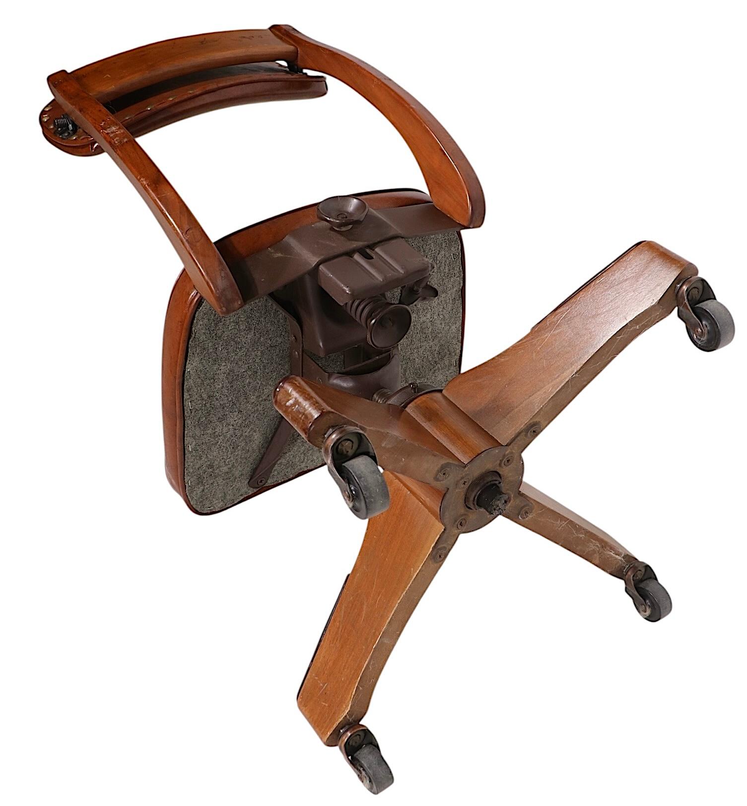 Stilvoller, drehbarer und kippbarer Schreibtischstuhl im Vintage-Stil mit Holzgestell, gepolstertem Sitz und Rückenlehne. Der Stuhl ist höhenverstellbar und die Rückenlehne ist in Position und Spannung verstellbar. Wahrscheinlich von bekannten