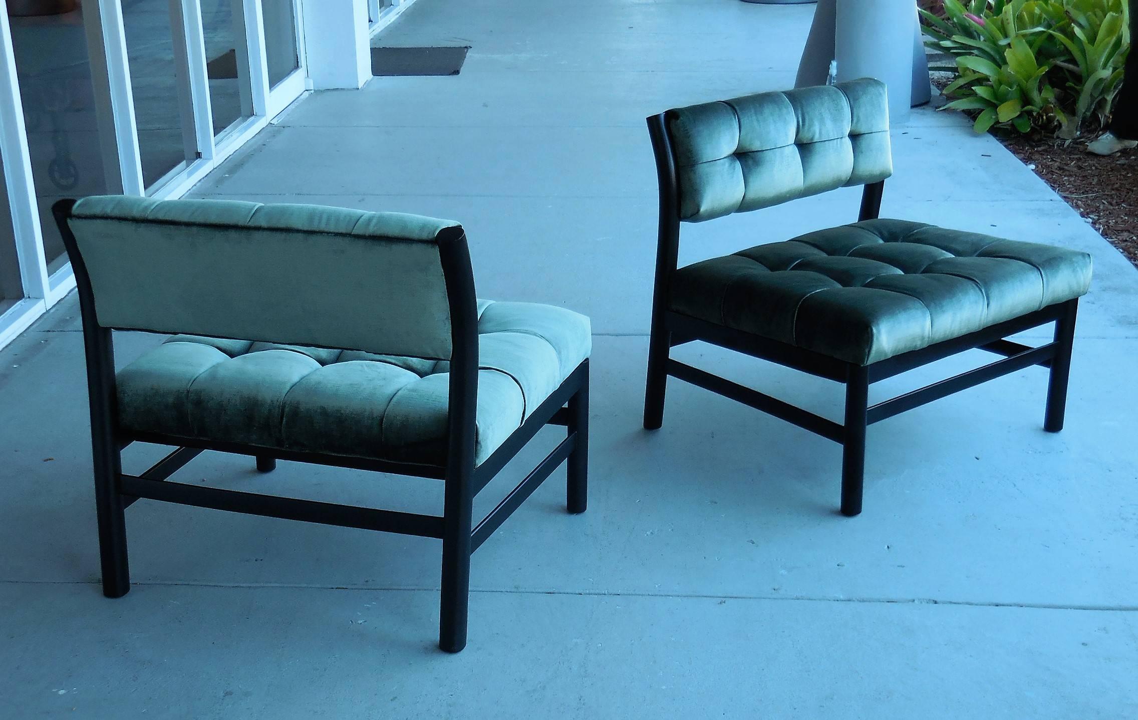 Pair of midcentury slipper chairs. Ebonized frames with tufted velvet upholstery. These chairs posses a casual elegant look that is both timeless and modern.