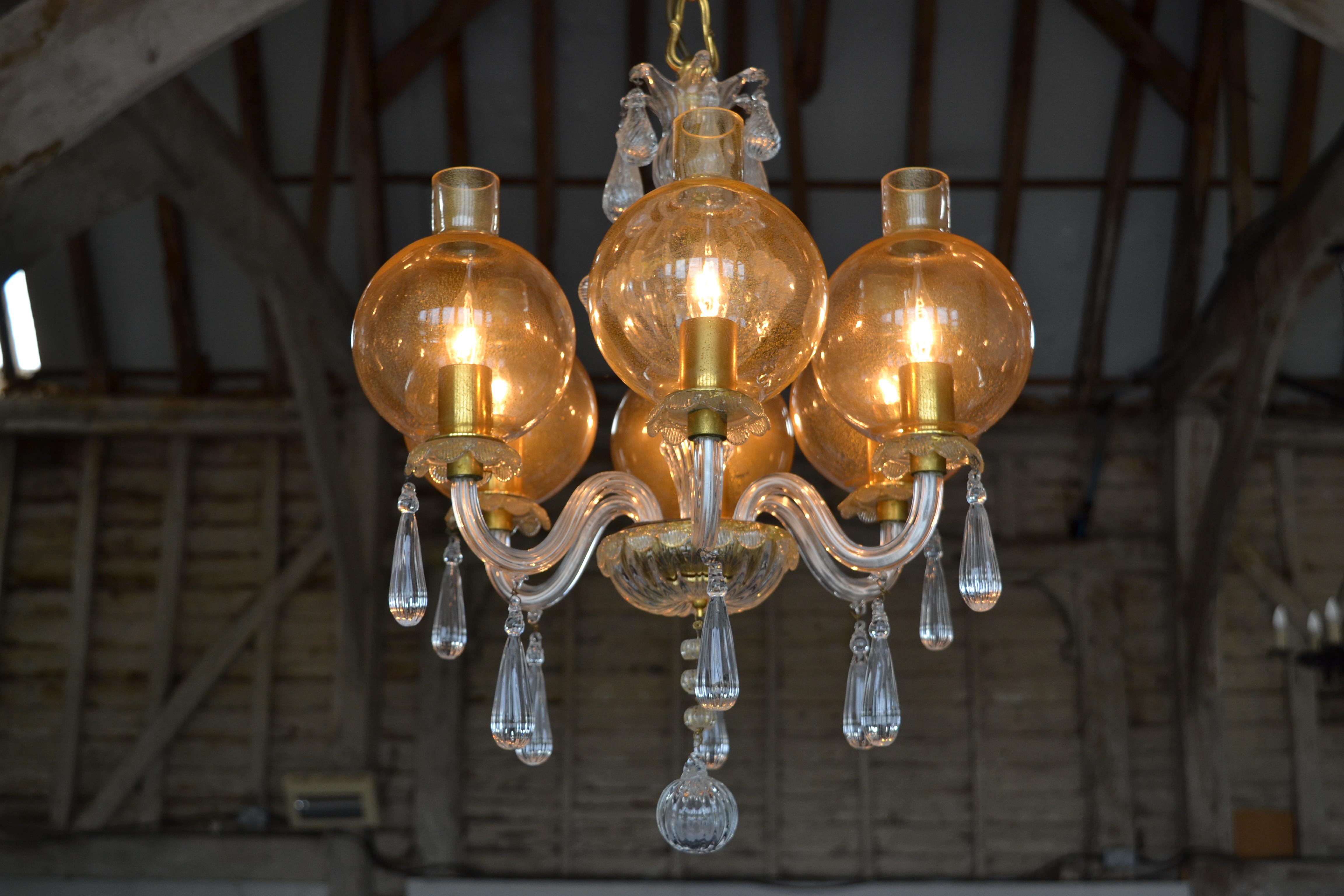 This exquisite Mid-Century Venetian Chandelier has 6 lights, classic Venetian detailing and extremely unusual Gold Flecked Storm Shades, we have never seen another chandelier quite like it. Perfect for a smaller living room or hallway.
