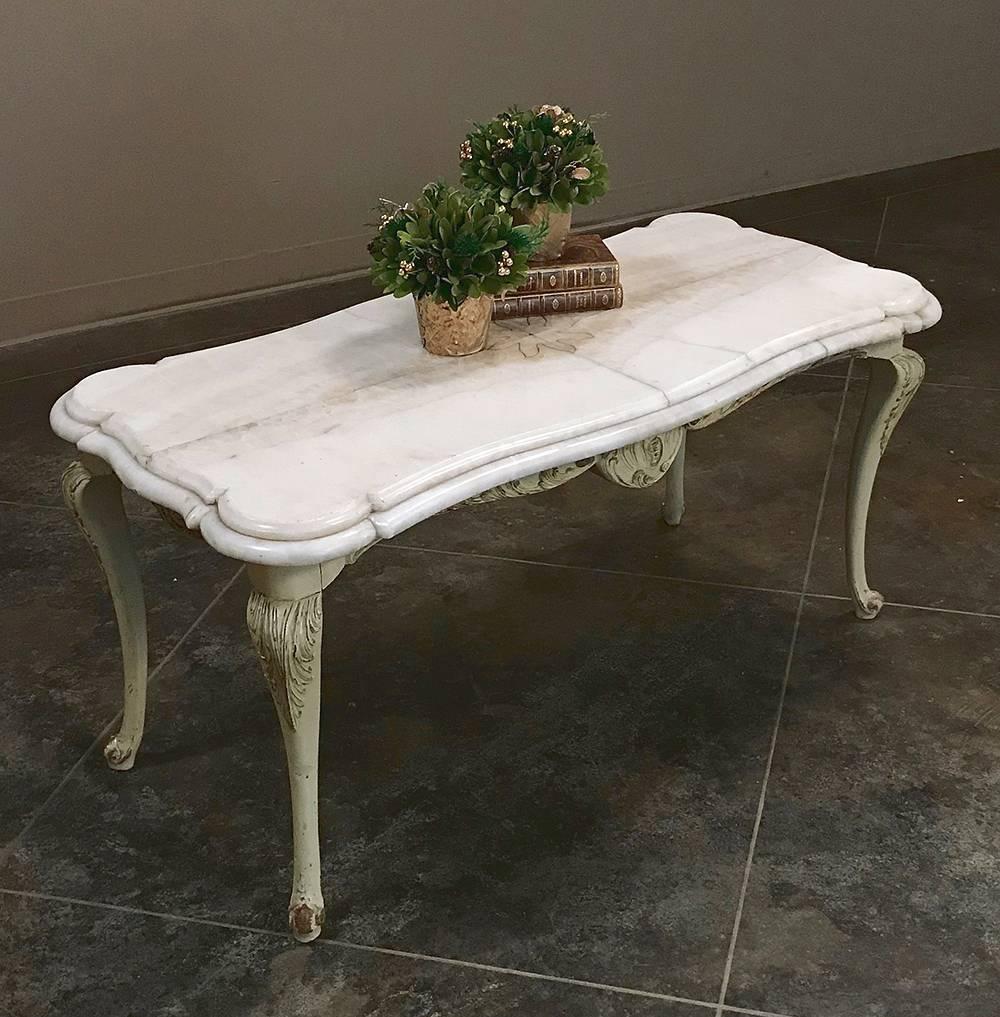 This elegant midcentury Venetian marble-top coffee table, circa 1950 features Baroque-inspired carved wood legs with a painted finish coupled with a luxurious pietra dura marble top,
circa 1950s
Measures 22 H x 44 W x 21.5 D.
