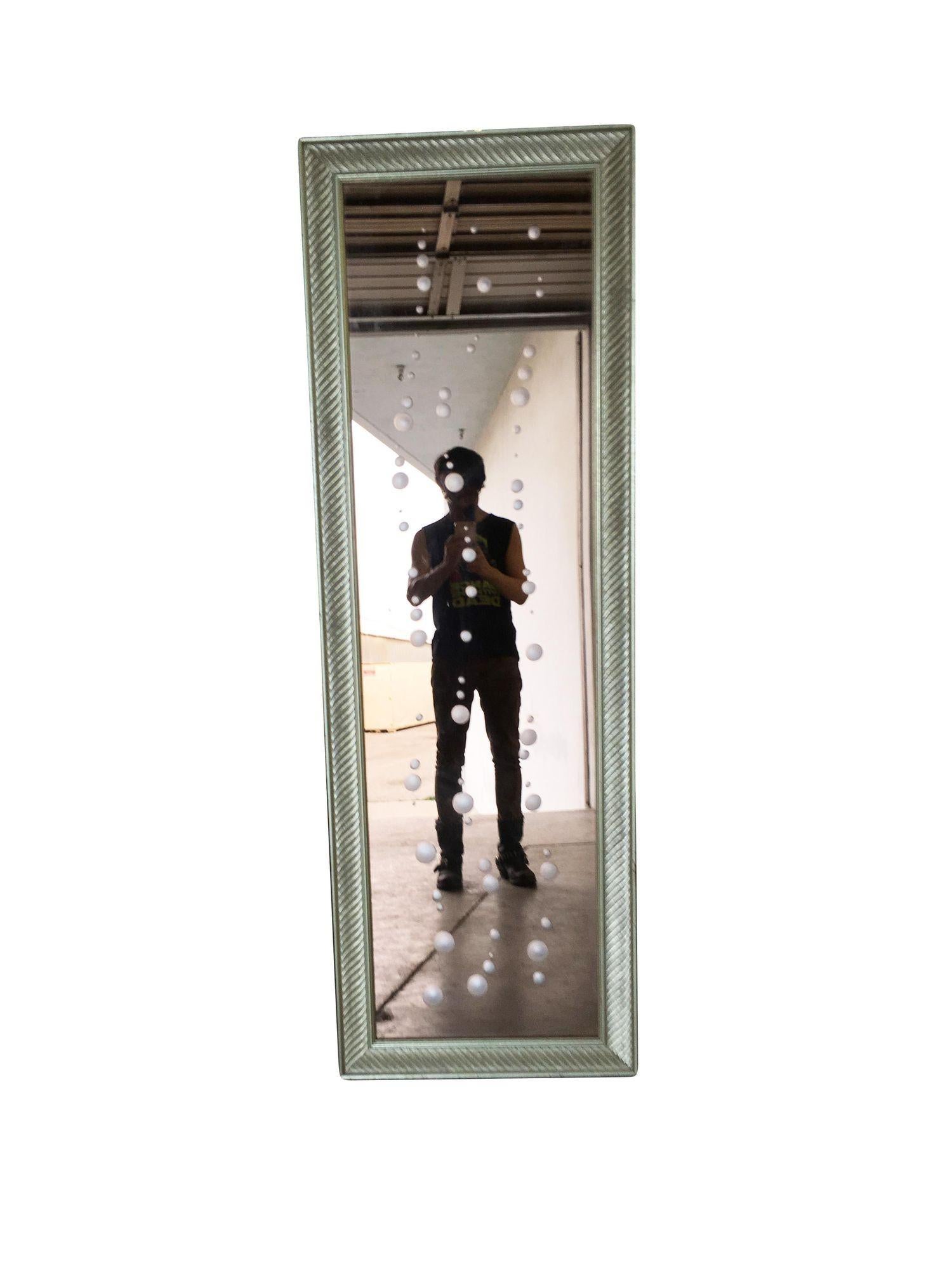 Mid-century Venetian peach glass floor mirror with hand-cut bubbles along the mirror's surface with original oak frame with a spiral pattern frame.

Dimensions: 42