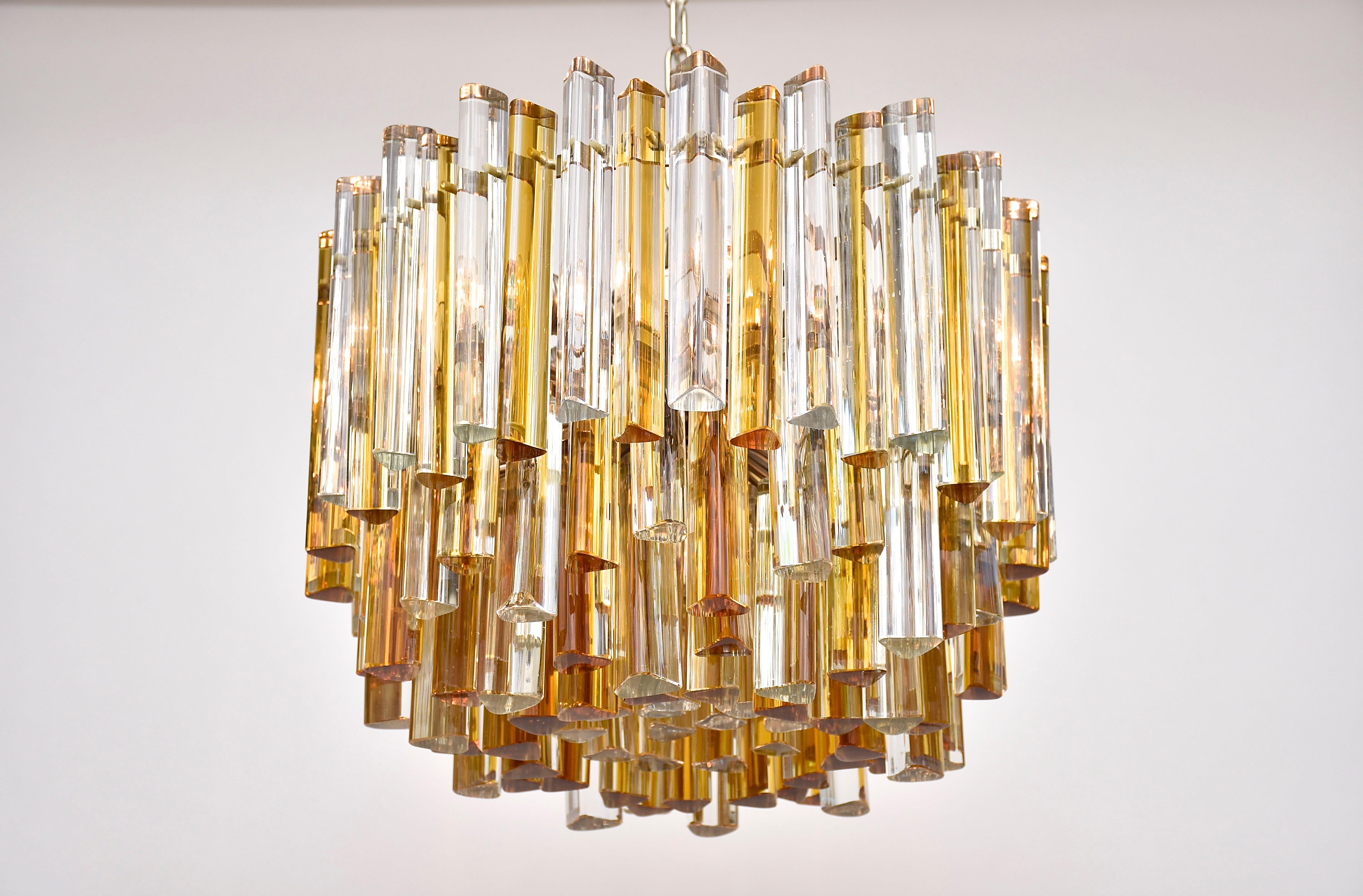 A beautiful Murano chandelier by Venini.
With 6 lights.
Model- 'Trilobo', clear and light amber coloured Murano crystals in very good condition. Strong and solid chromed frame.  
Period- 1970, mid-century modern
Place of origin- Italy
