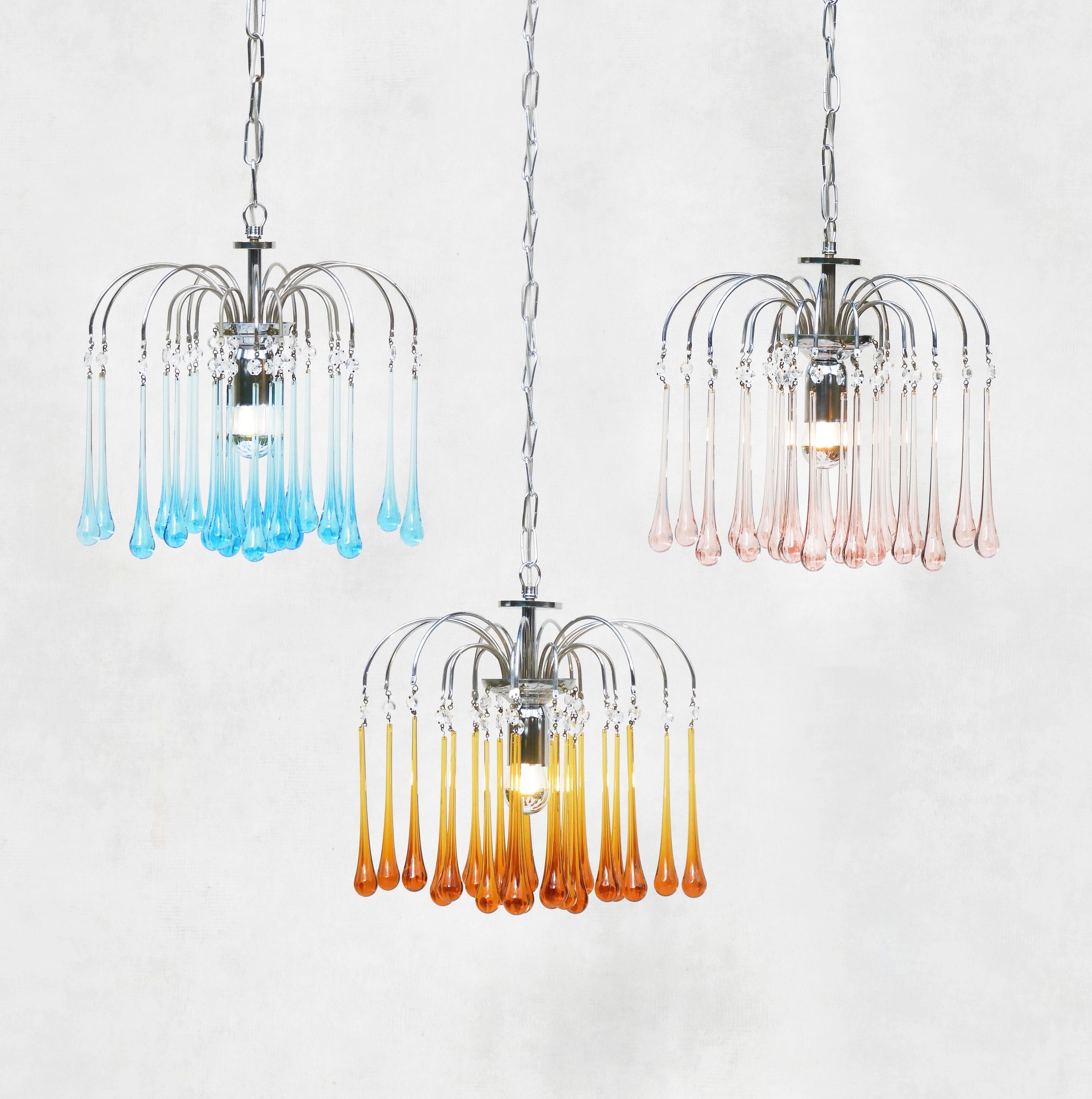 Stunning Paulo Venini Style waterfall pendant chandeliers.

A matched set of three beautiful Murano glass cascade pendant lights, each with 24 transparent ‘teardrop’ crystals on a three-tier chrome frame. 

In great vintage condition with good