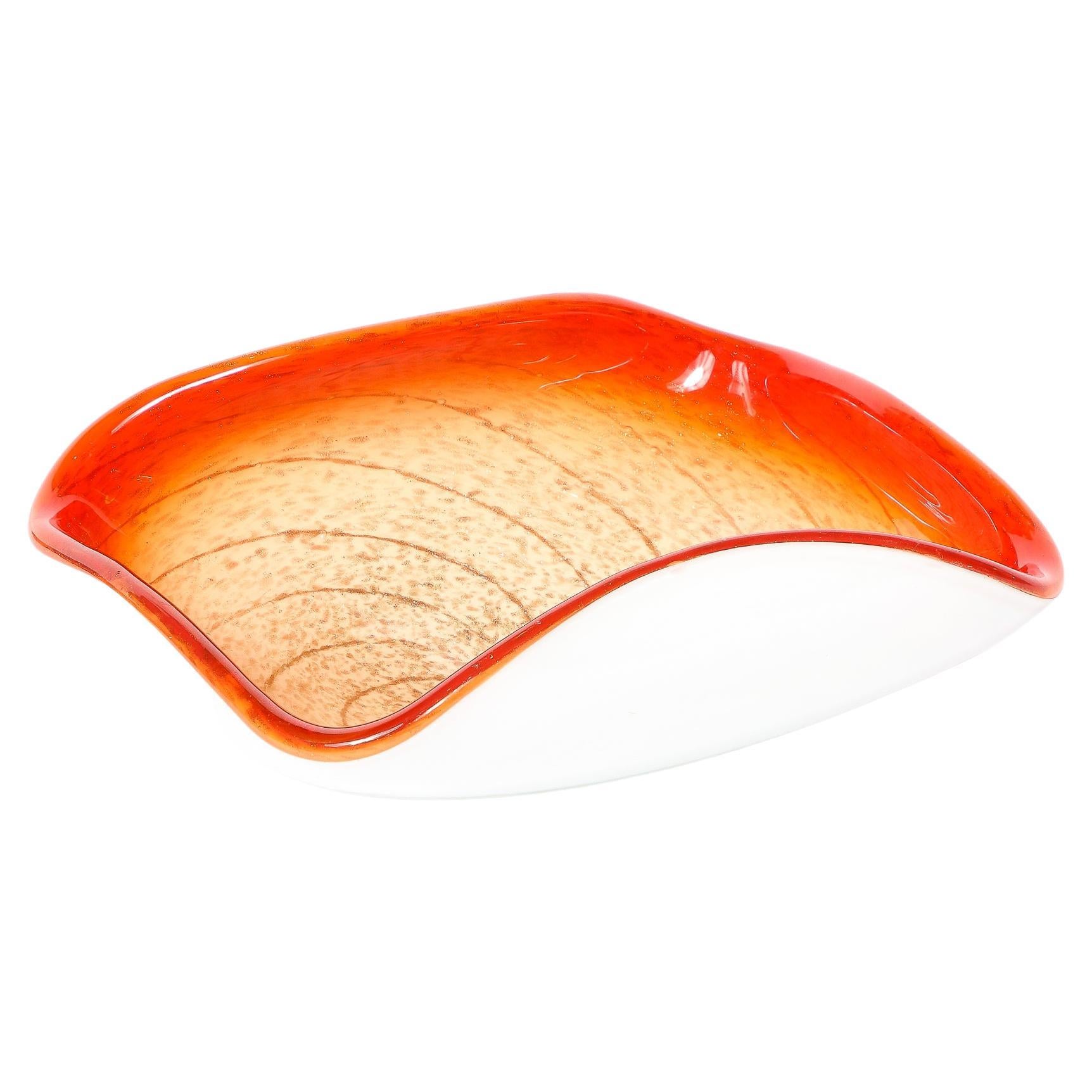 -This vibrant Mid-Century Modernist Hand-Blown Murano Glass dish originates from Italy, Circa 1960. In a rounded square shape with a snow white undersurface curving up to form the space of the dish, the bright colors jump from the center. The edge