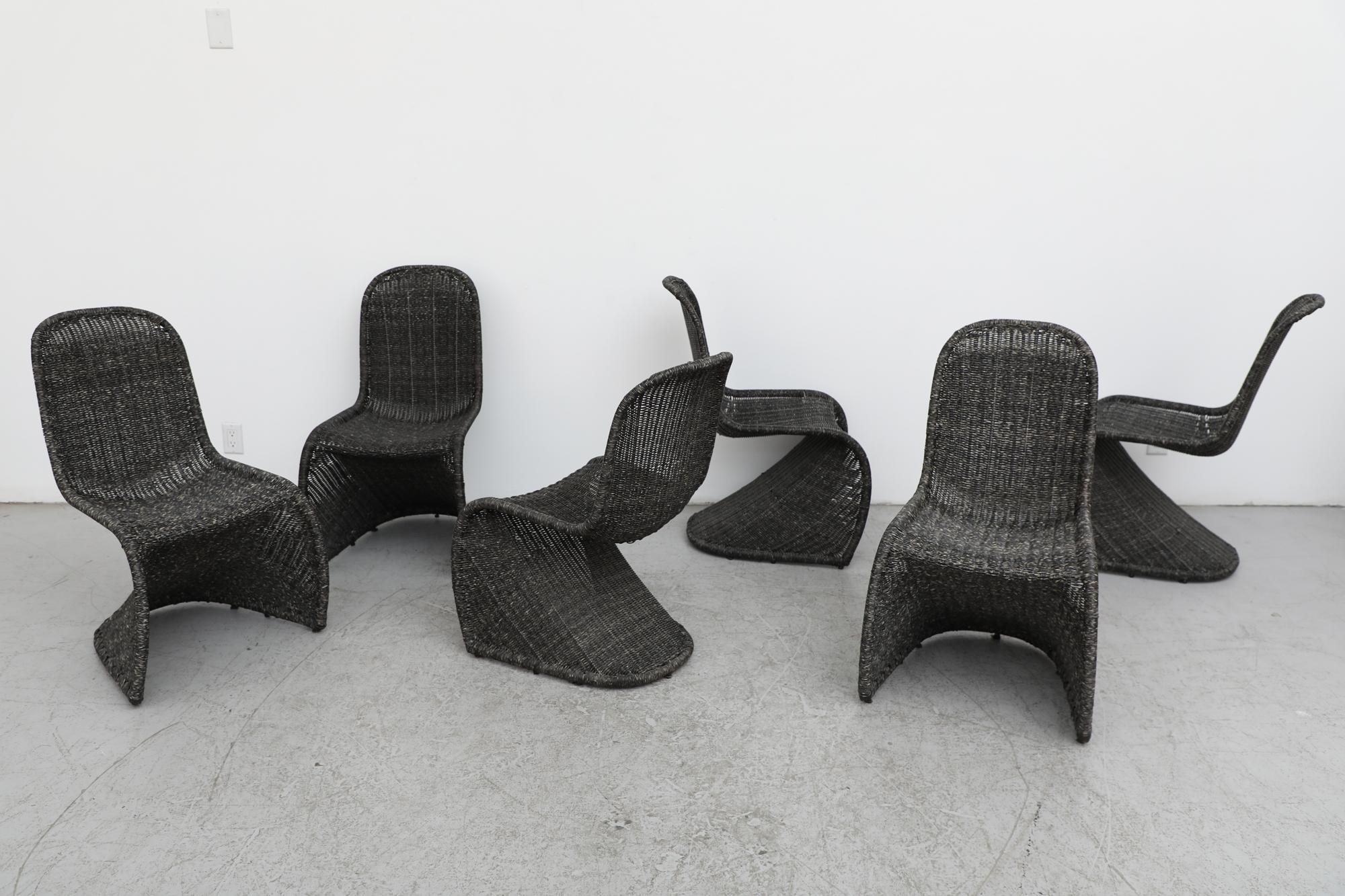 Set of six Mid-Century Verner Panton style stacking wicker rattan chairs. Reminiscent of the Panton chair which, in the annals of furniture design, is an absolute classic. That chair was designed by Verner Panton in 1959 and developed for mass