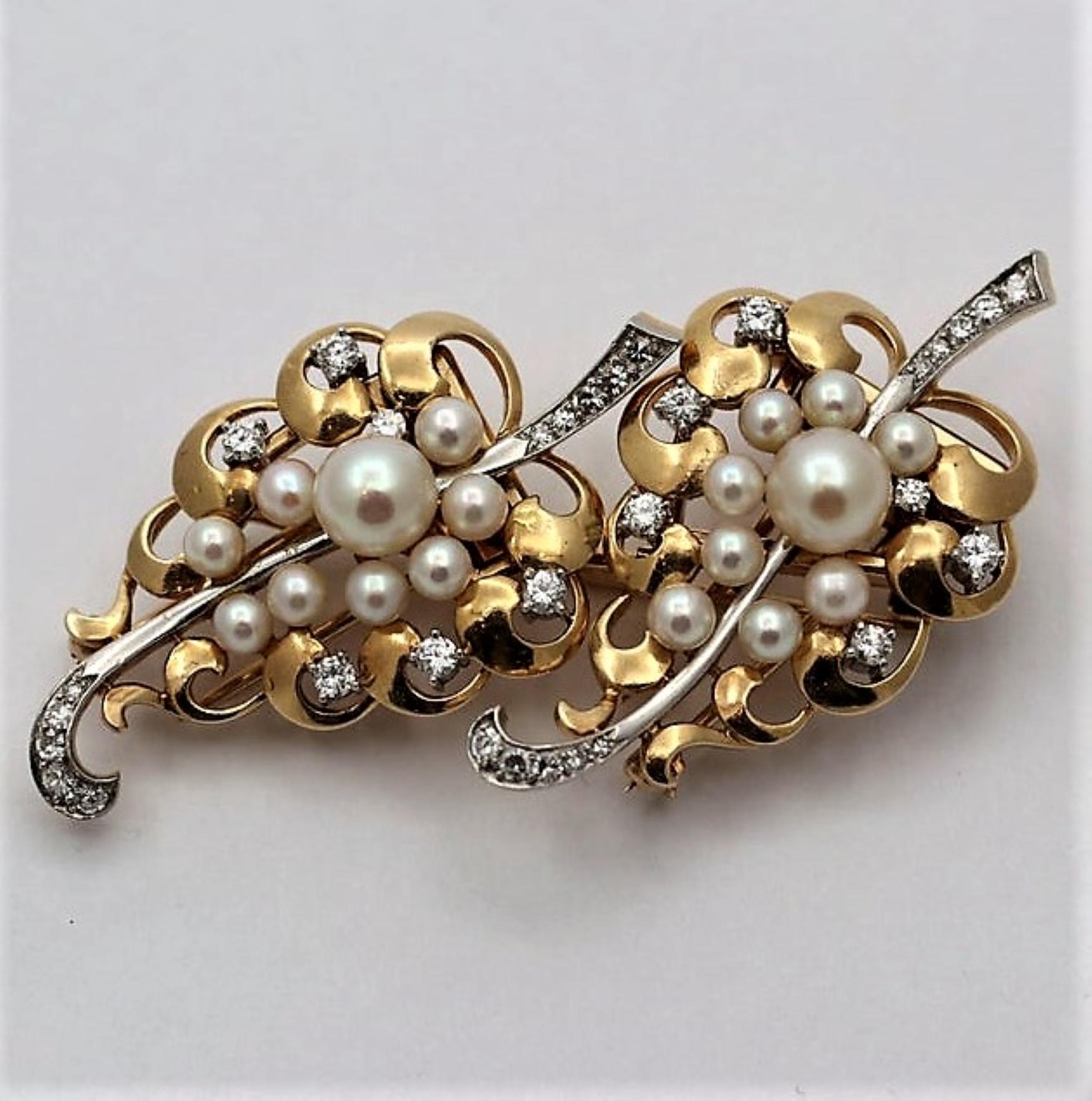 A pair of mid 20th century double clips, complete with chassis to form one brooch, and embellished with a total 
of 20 cultured pearls and set with assorted round brilliant cut and single cut diamonds weighing a total of approximately 0.85ct. Using
