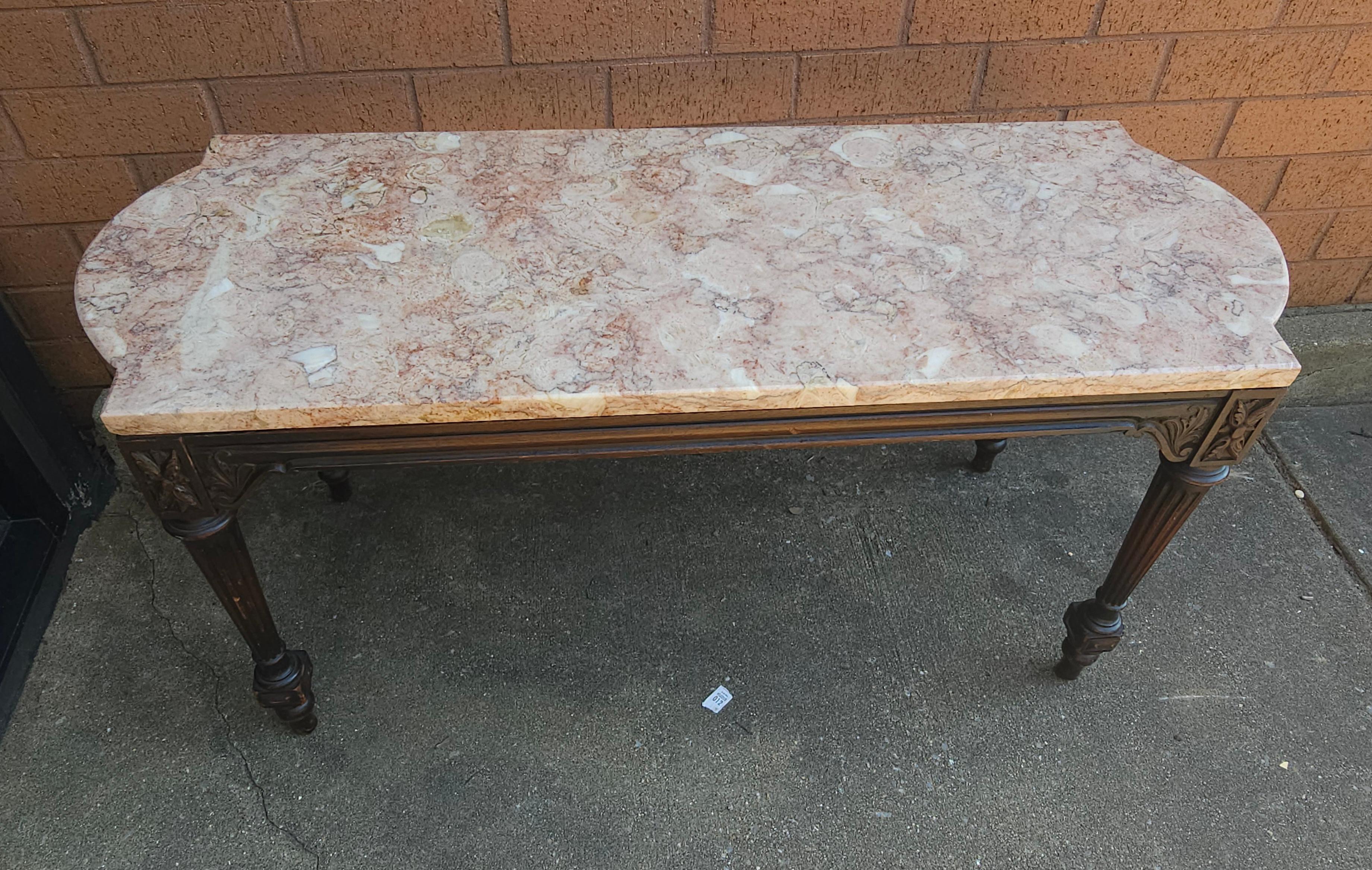 A Mid Century Victorian Style Carved Mahogany Marble Top Cocktail Table. Measures 39.25