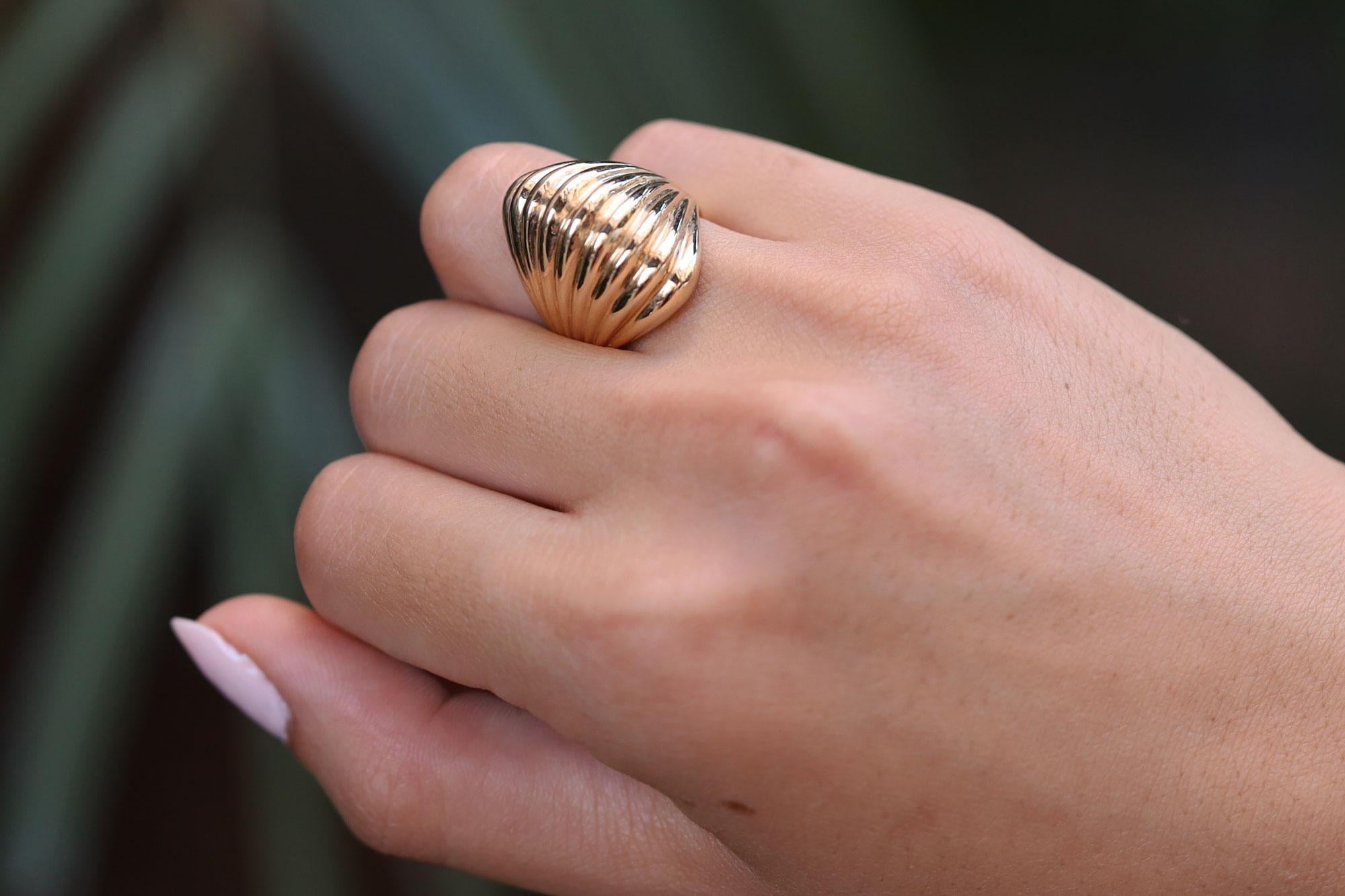 This exquisite mid-century statement piece is a sustainable estate jewel, expertly handcrafted with 14k yellow gold. Experience the impressive dome display and finger coverage of this weighty ring. Sure to garner many compliments, don't hesitate to