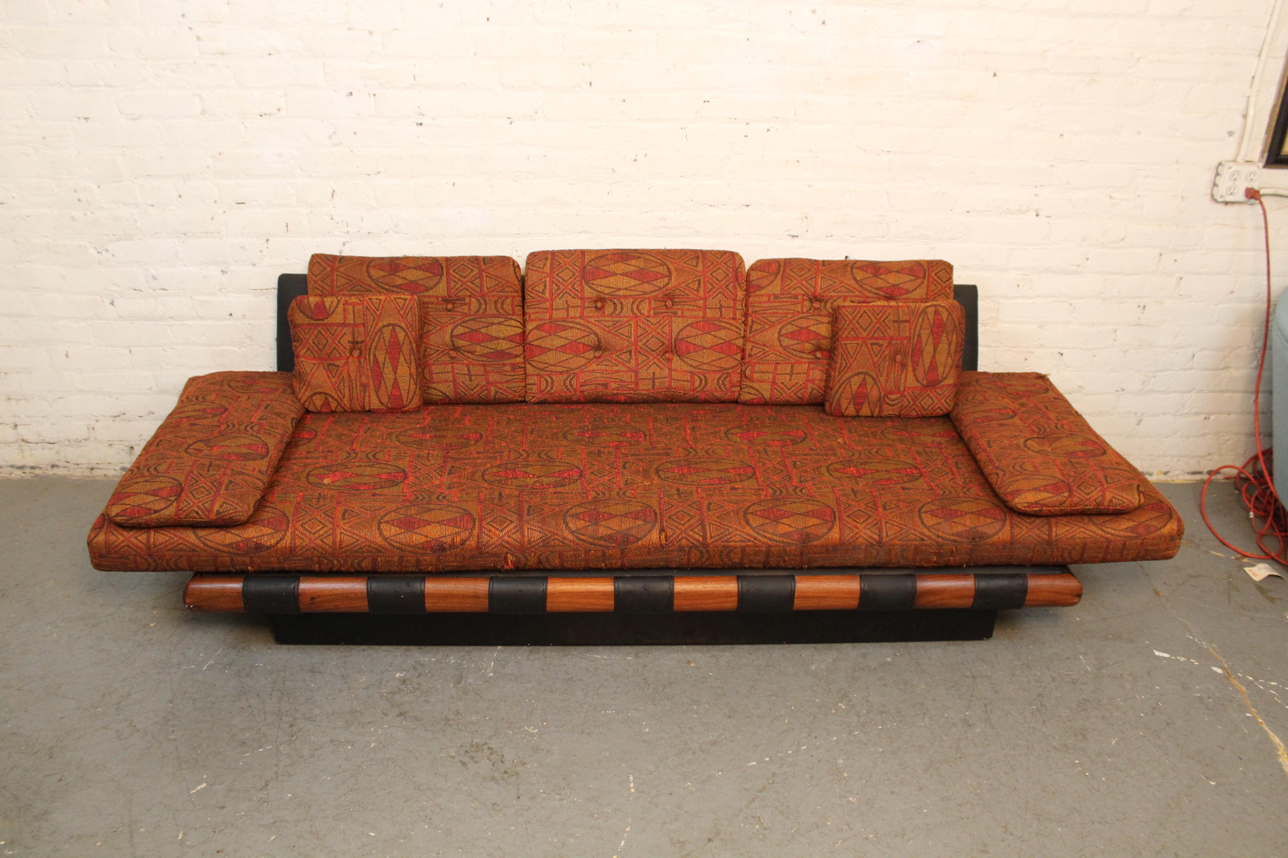 Don’t miss out on this highly unusual and intriguing sofa from the portfolio of American mid-century design master Adrian Pearsall. Manufactured for his Craft Associates brand of Wilkes-Barre, Pennsylvania, this robust plinth-base couch/daybed