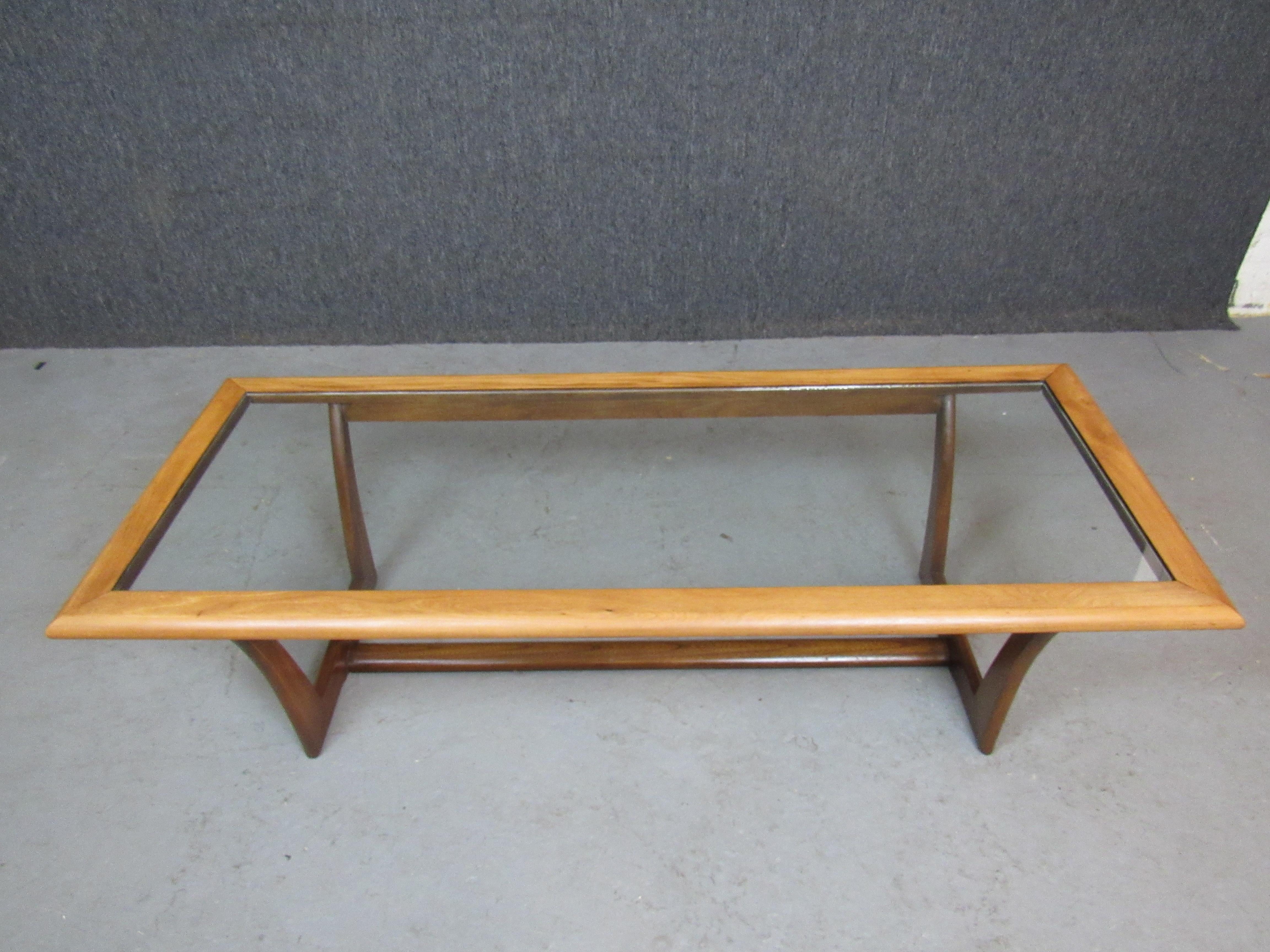 Wonderfully unique mid-century American coffee table, featuring a newly refinished two-tone oak frame, inset glass top, and a carved sled base.  Borrowing aesthetic cues from classic Scandinavian modern builders such as Peter Løvig Nielsen and