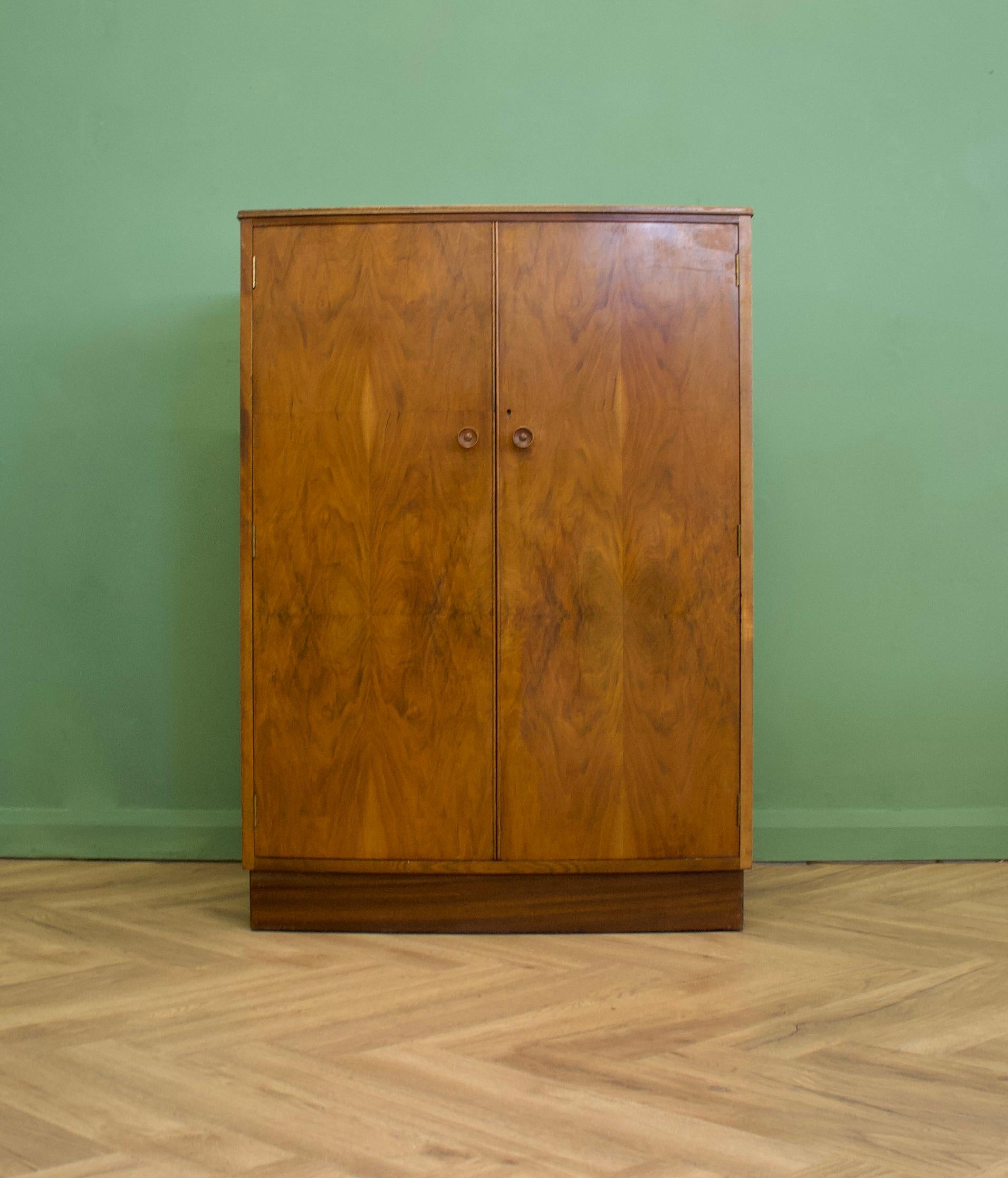A vintage walnut Art Deco style compactum / compact wardrobe
Inside is fitted out with a pull out rail, three drawers and shelf
It also features solid wood handles.


 